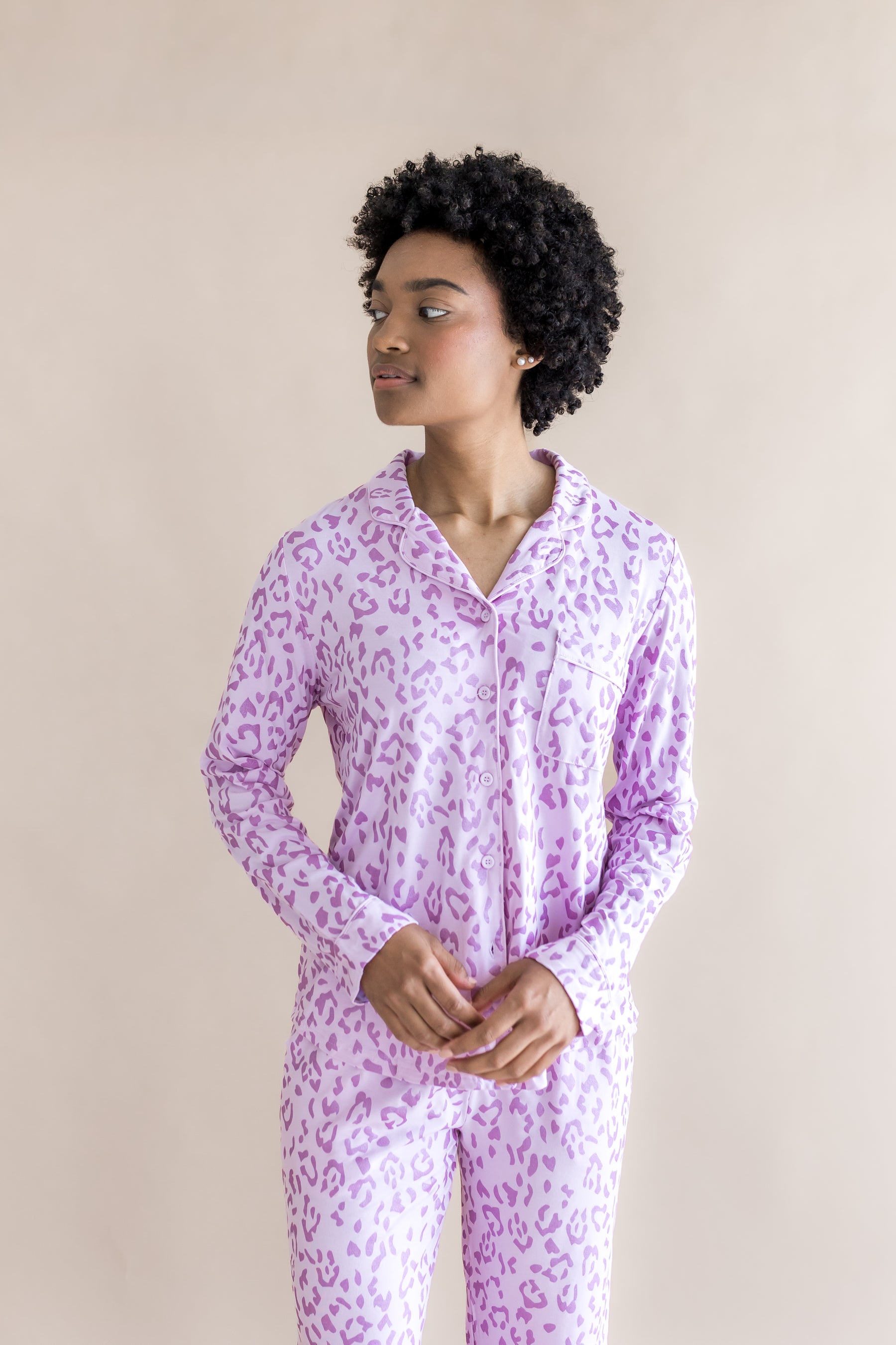 Model wearing Women's Long Sleeve Pajama Set in Thistle Leopard print on a beige background