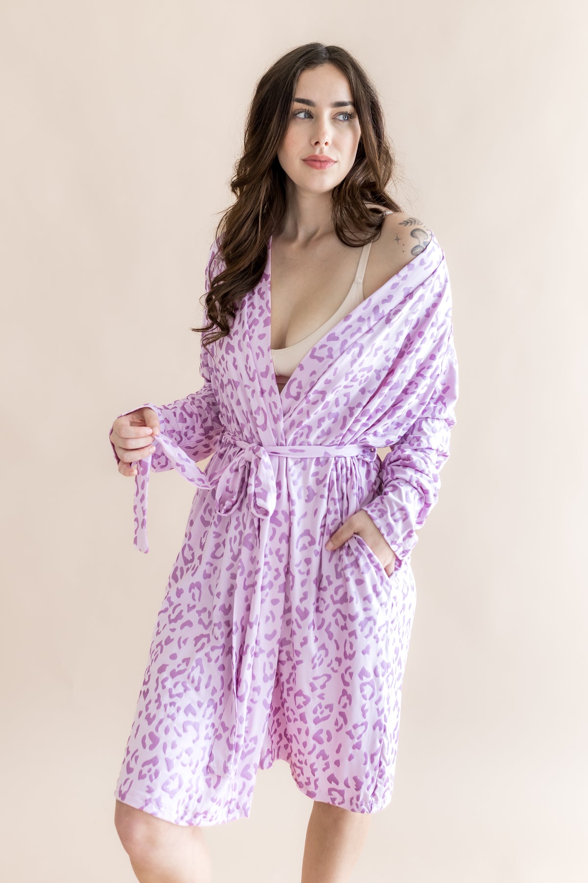 Model wearing Women's lounge robe in Thistle Leopard print on a beige background
