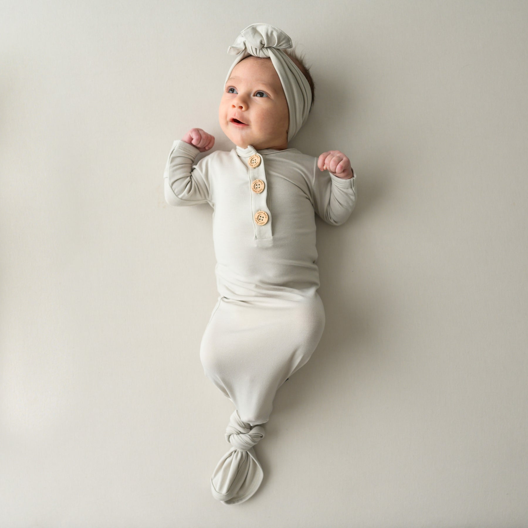 Baby wearing Knotted Gown with Bow Set in Oat 