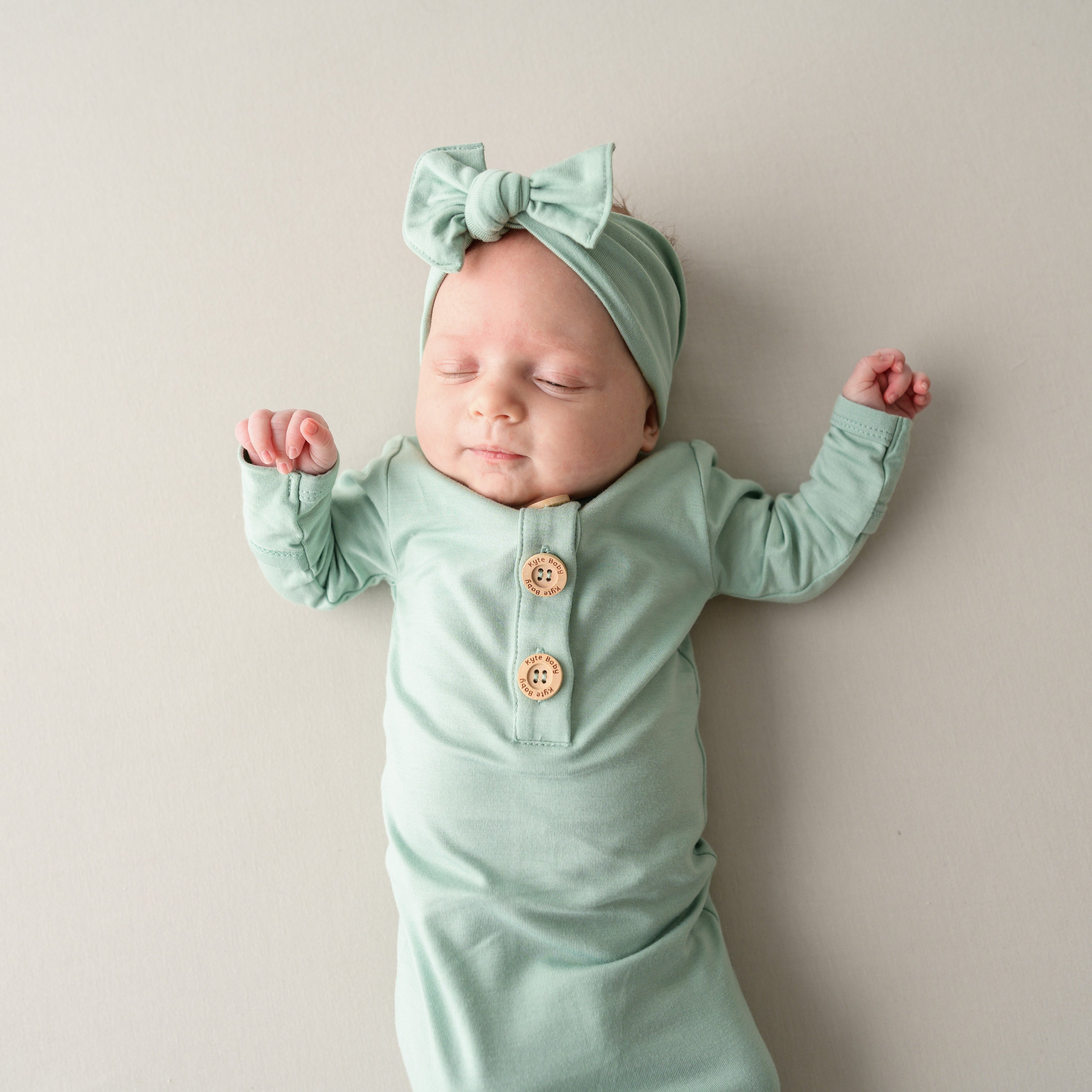 Knotted Gown with Bow Set in Sage  on sleeping baby close up