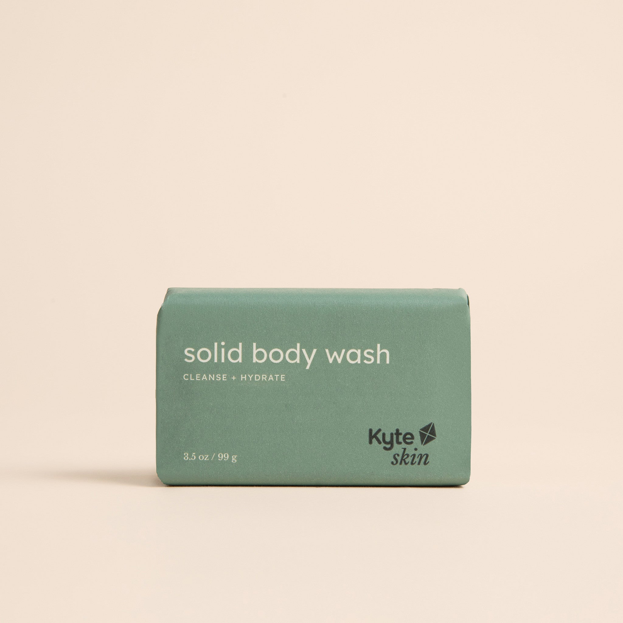 Green bar of solid body wash with 'Kyte Skin' branding on a beige background