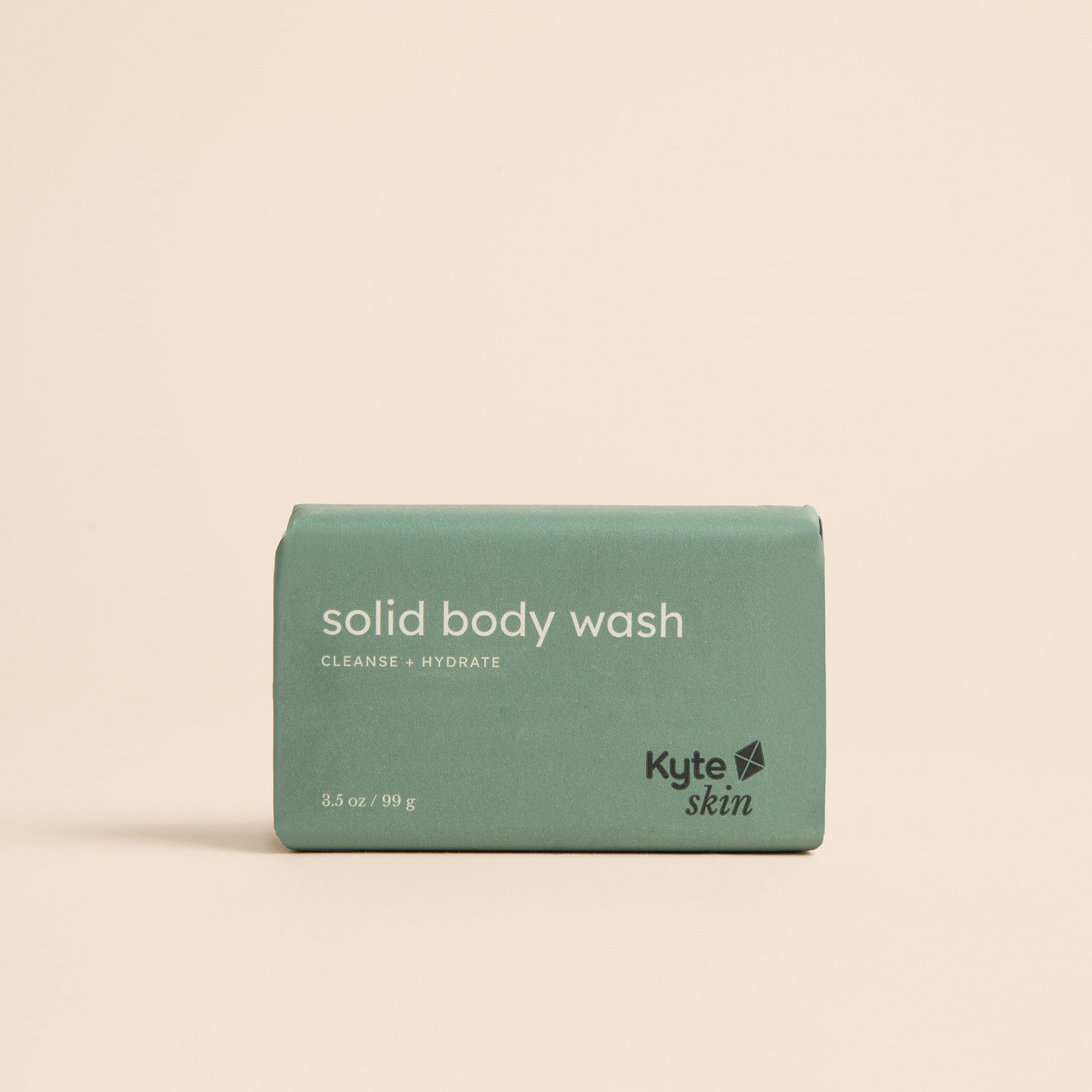 Green bar of solid body wash with 'Kyte Skin' branding on a beige background