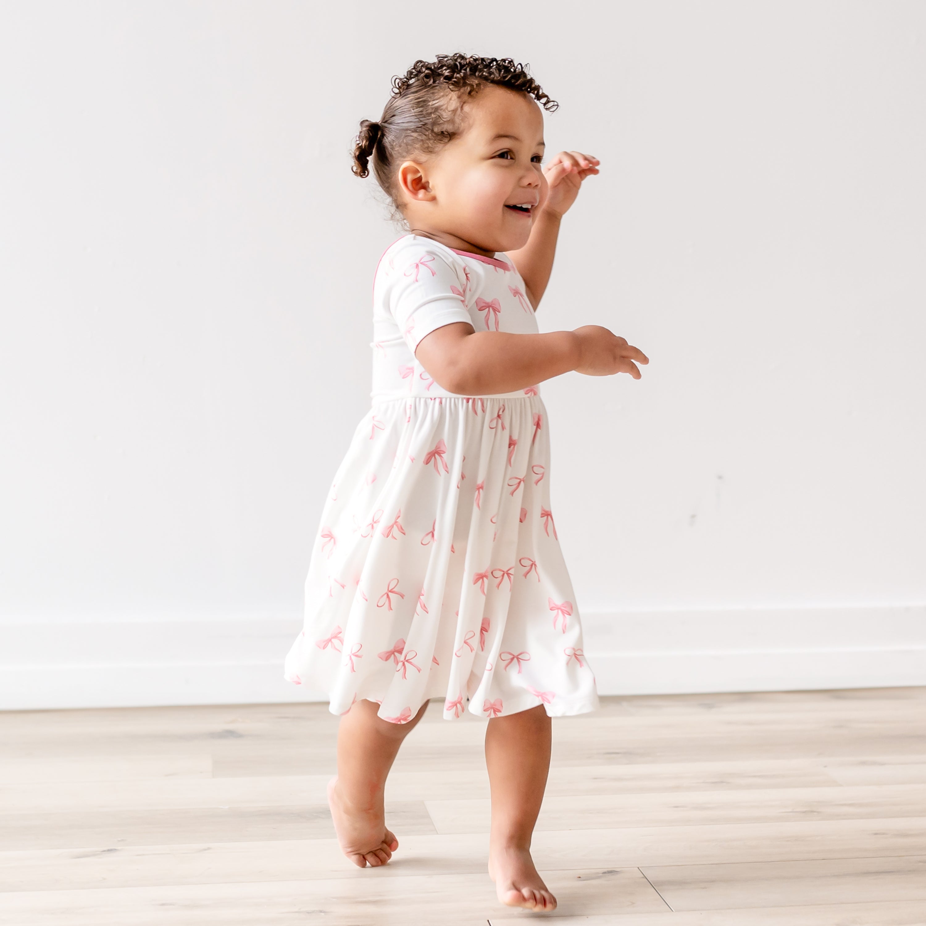 Little girl playing in Twirl Dress in Bow