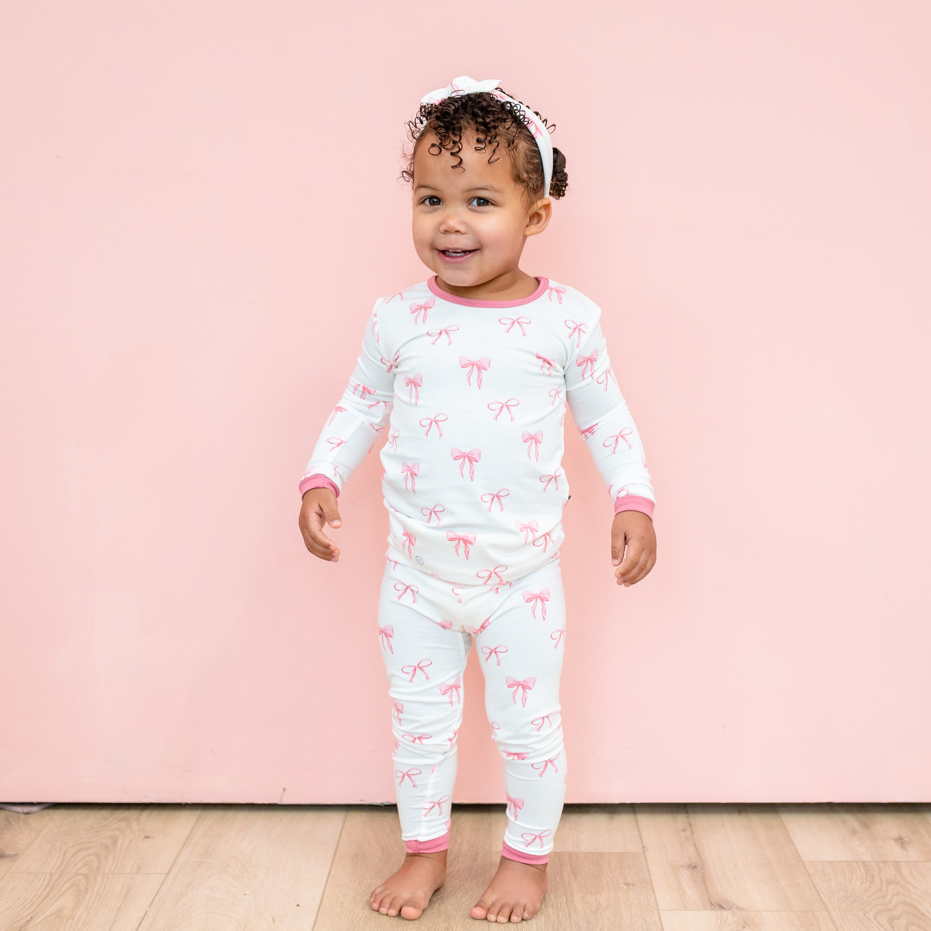 Toddler wearing Bamboo Pink Long Sleeve Pajamas in Bow