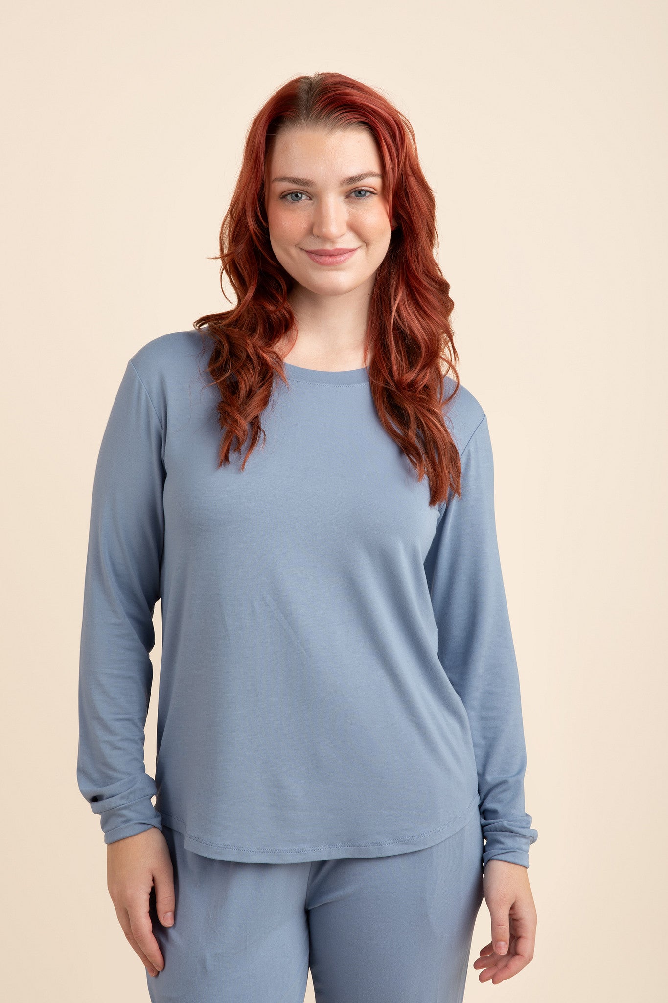 Woman wearing a slate blue jogger top and matching bottoms