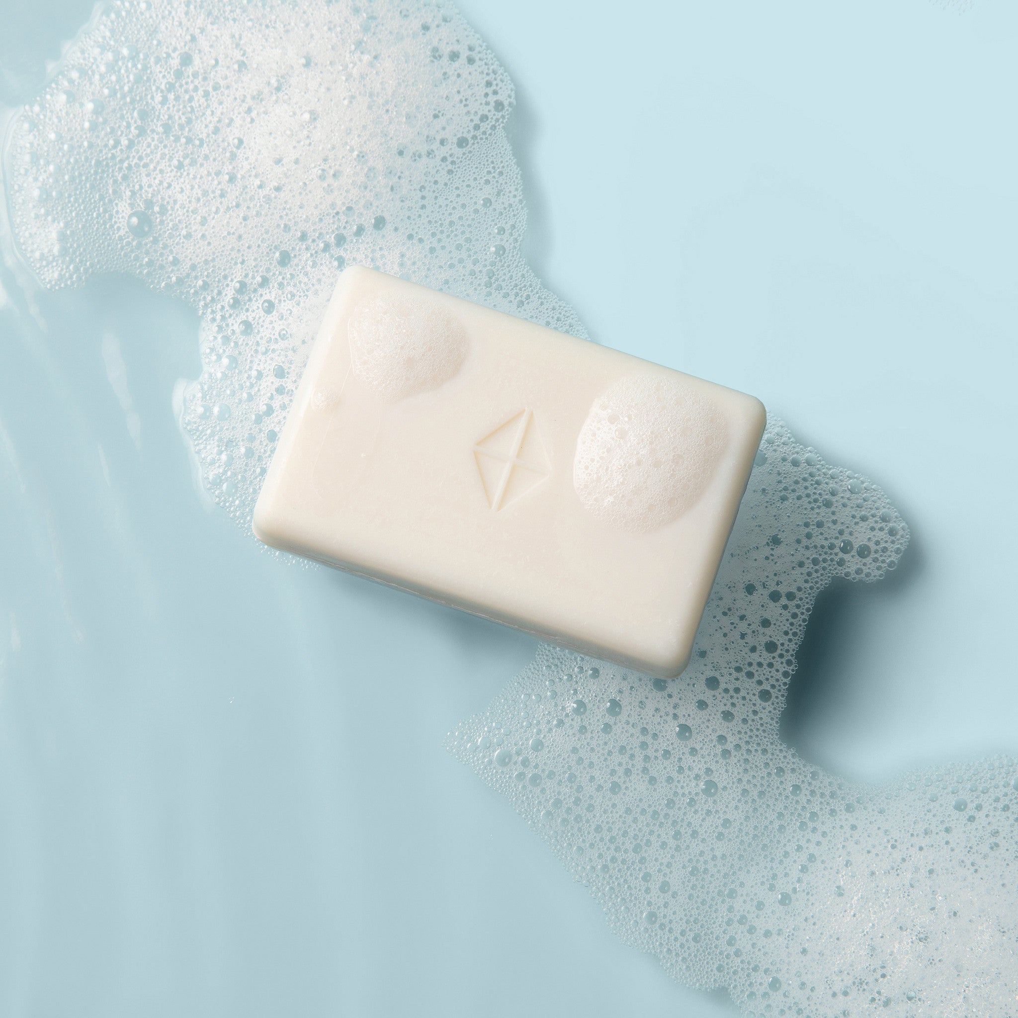 Bar of soap with a Kyte Skin logo on a light blue background