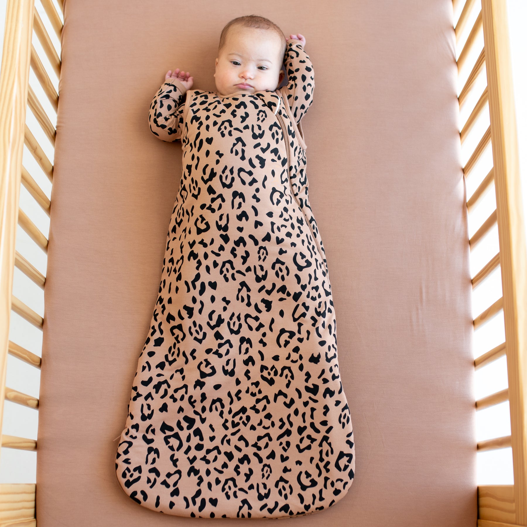 Infant wearing bamboo Sleep Bag in Latte Leopard 1.0