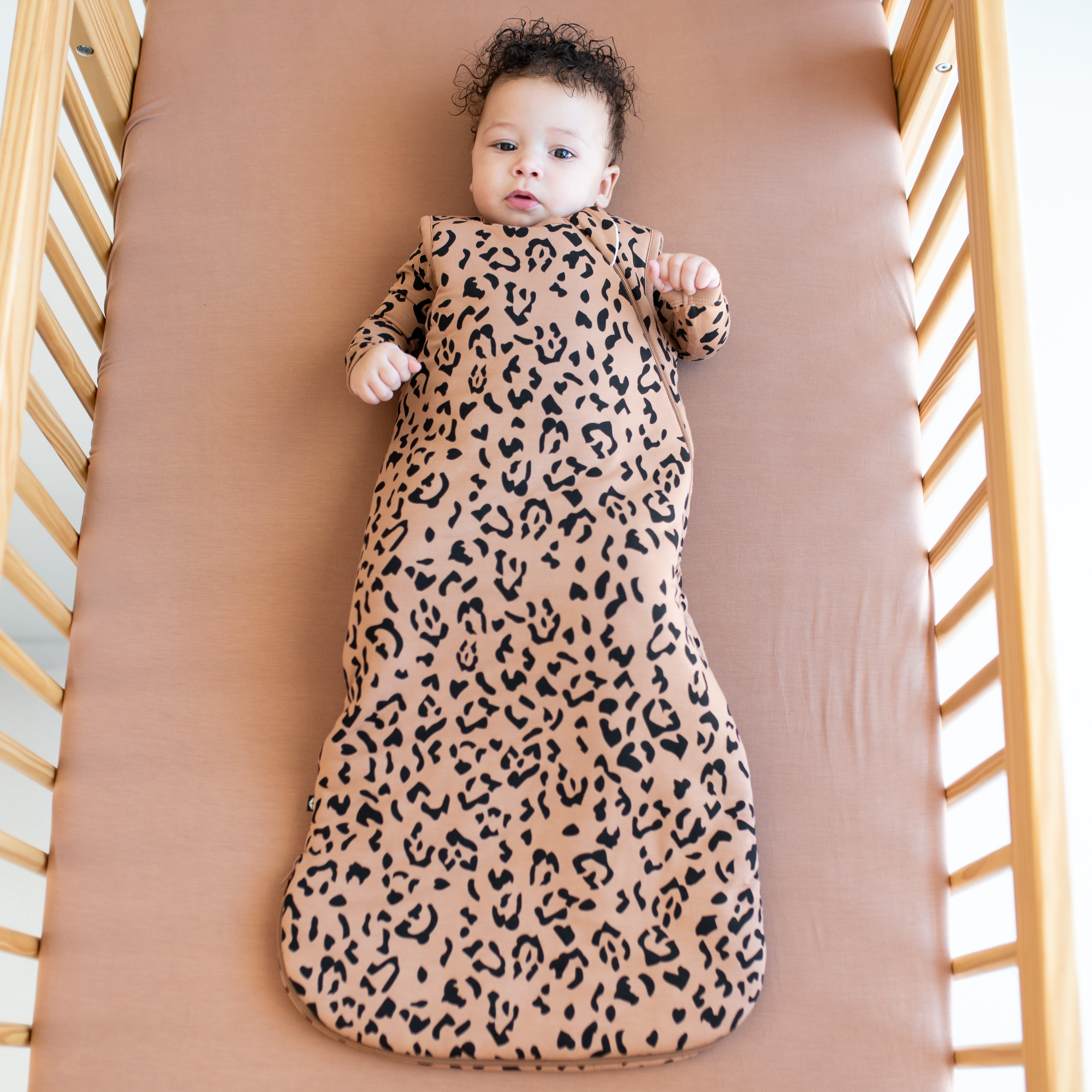 Baby wearing the Sleep Bag in Latte Leopard TOG 2.5
