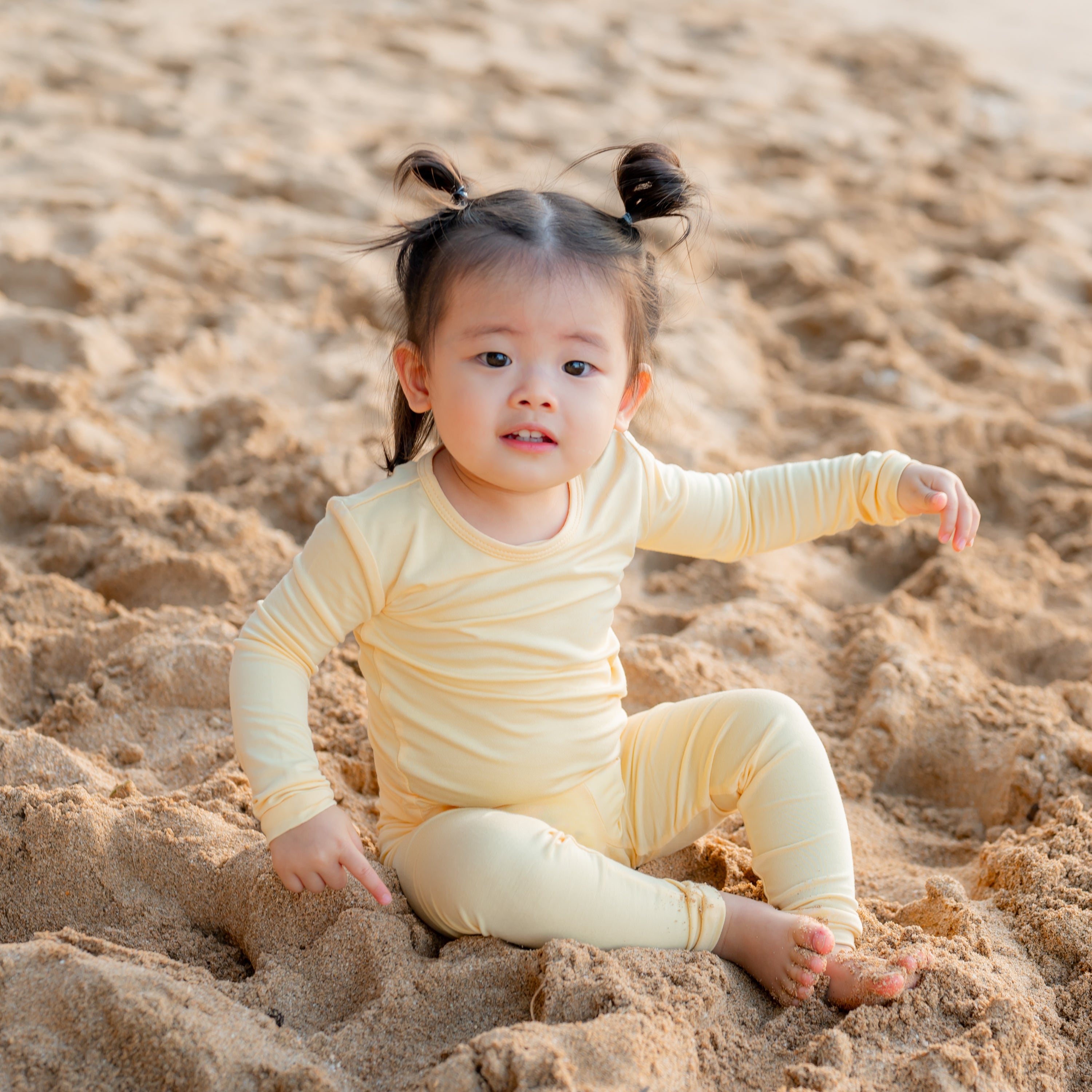 Young toddler wearing Lilikoi Long Sleeve Pajamas on the beach