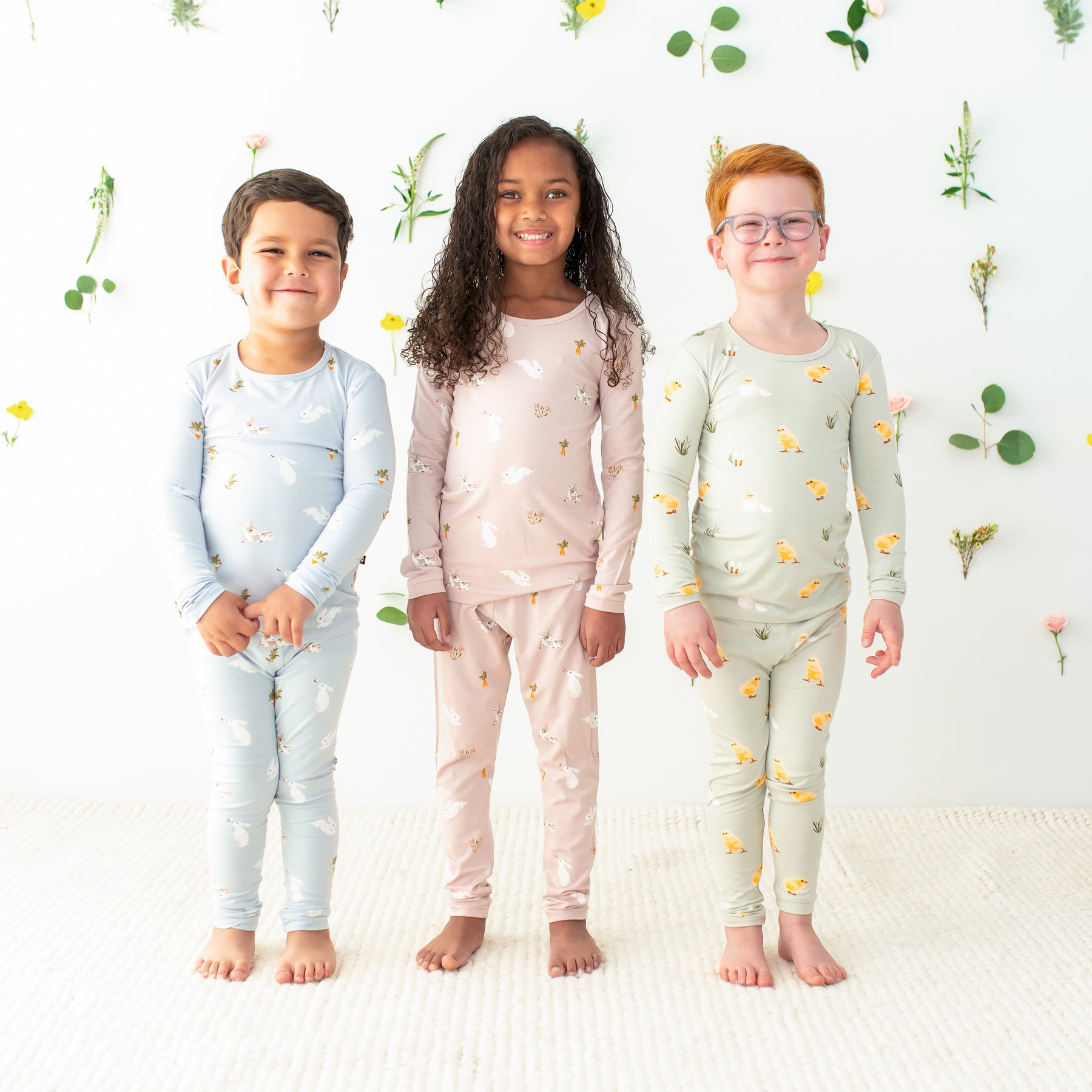 3 toddlers wearing kyte baby easter prints in long sleeve pajamas