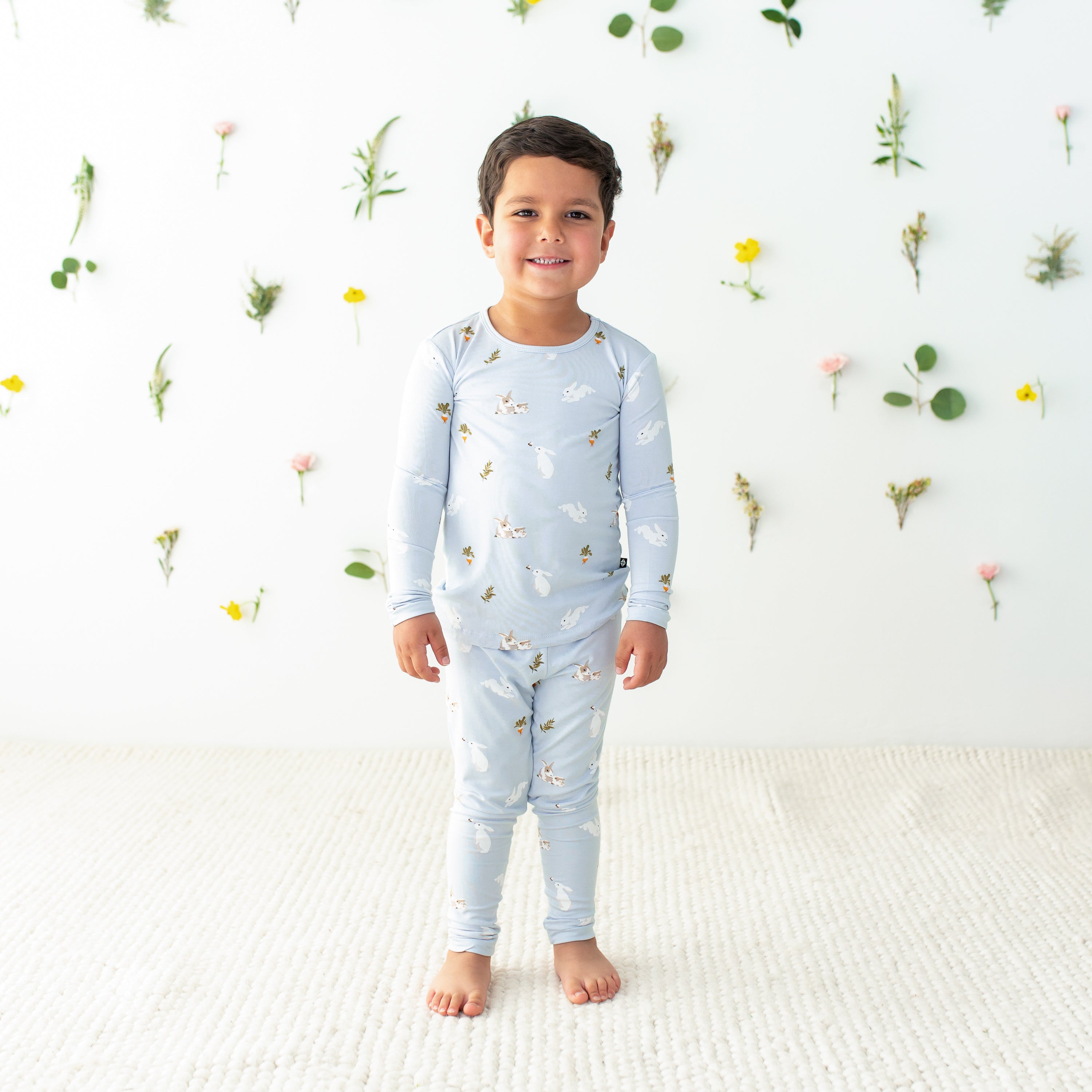 Toddler modeling Long Sleeve Pajamas in Ice Rabbit