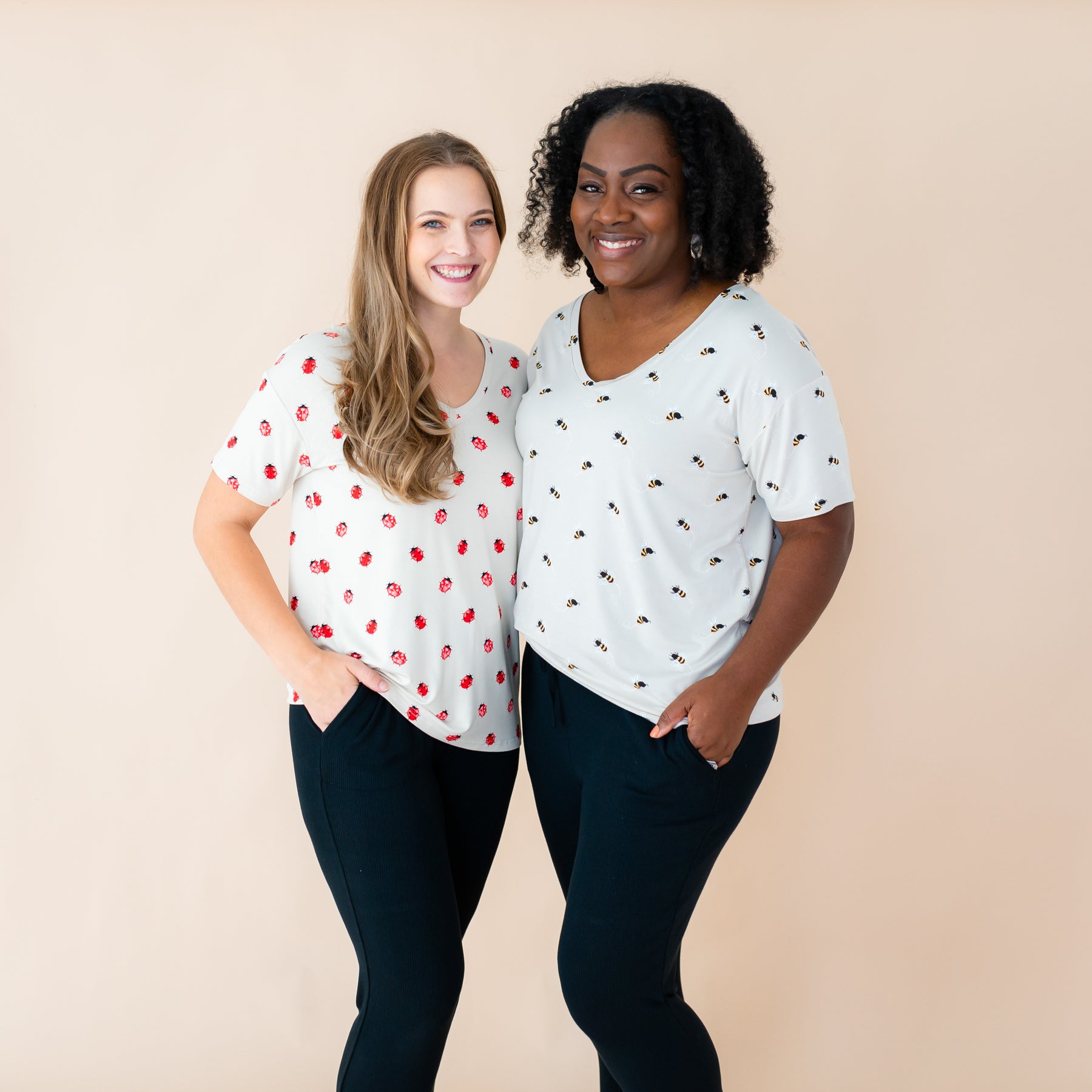 Two woman modeling v-necks in Love Bug and Bee Mine