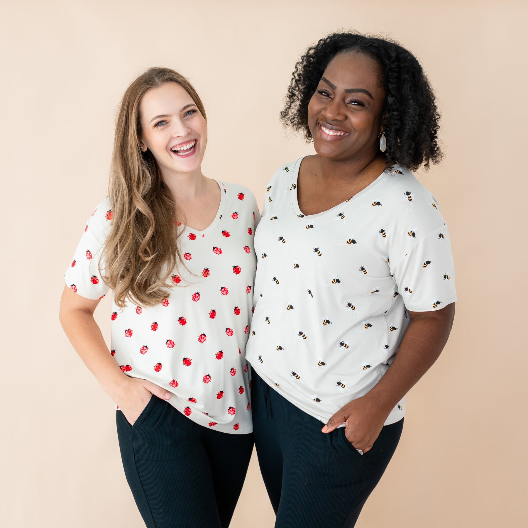 Women modeling v-neck tees in the prints Love Bug and Bee Mine