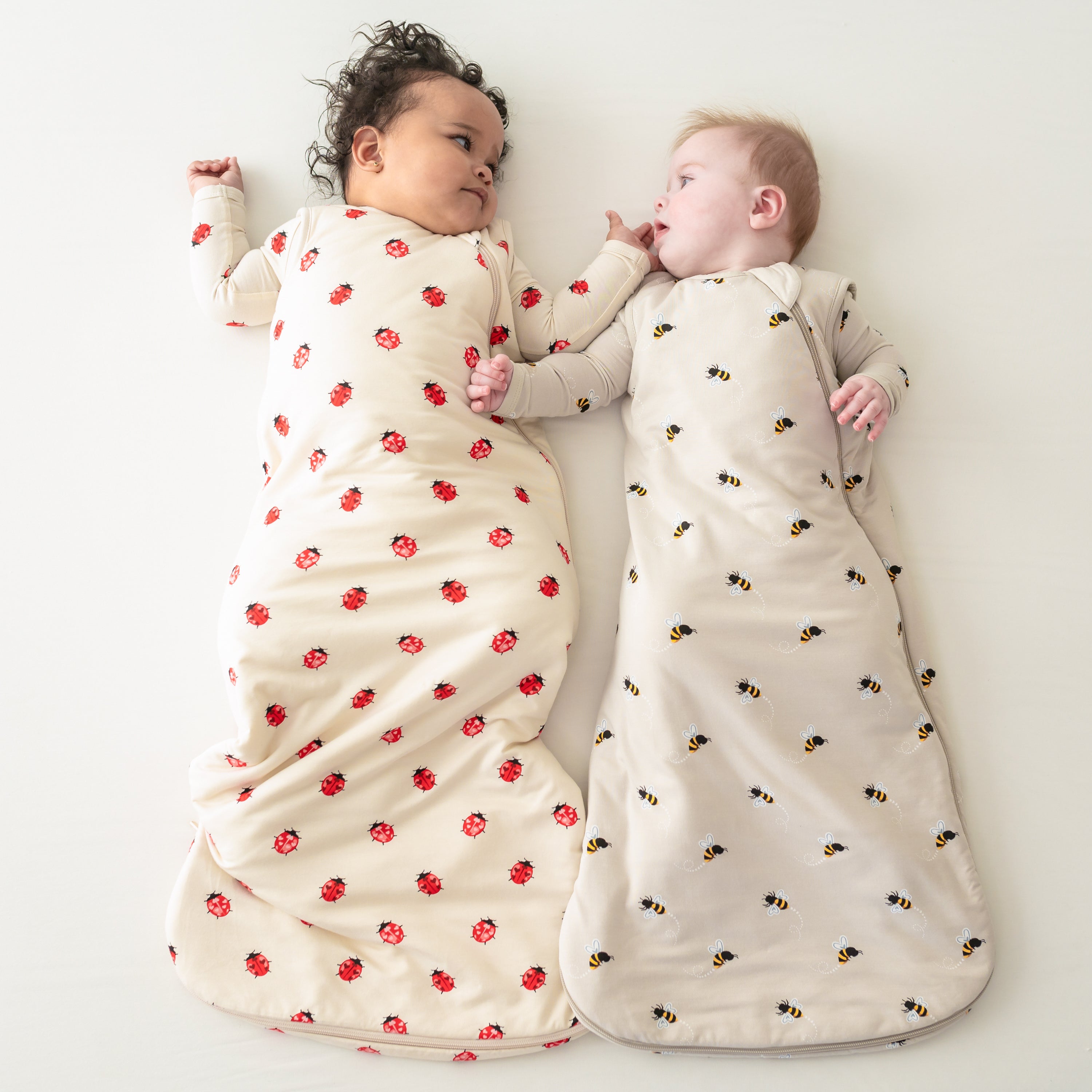 Two babies wearing Sleep Bags in Love Bug and Bee Mine