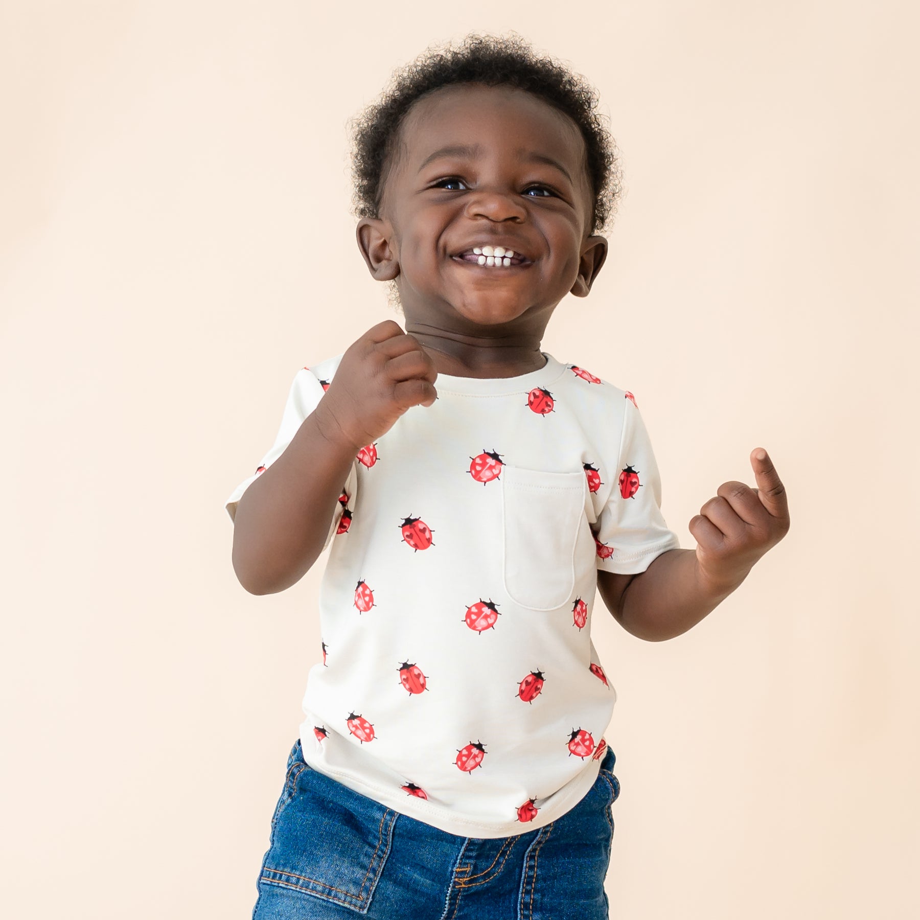 Close up shot of toddler wearing Love Bug crew neck tee