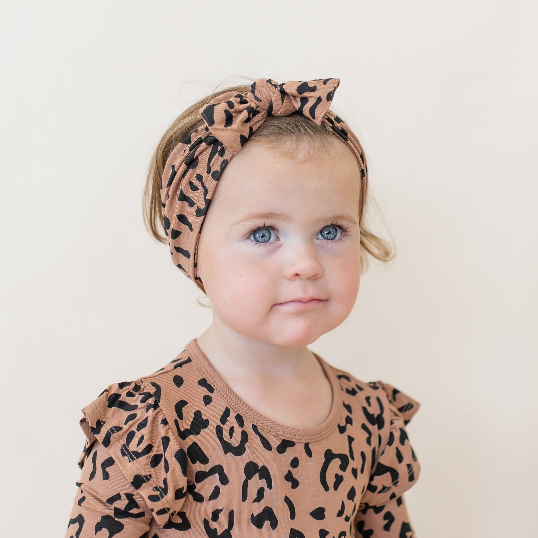 Toddler wearing Knotted Bow Headband in Latte Leopard