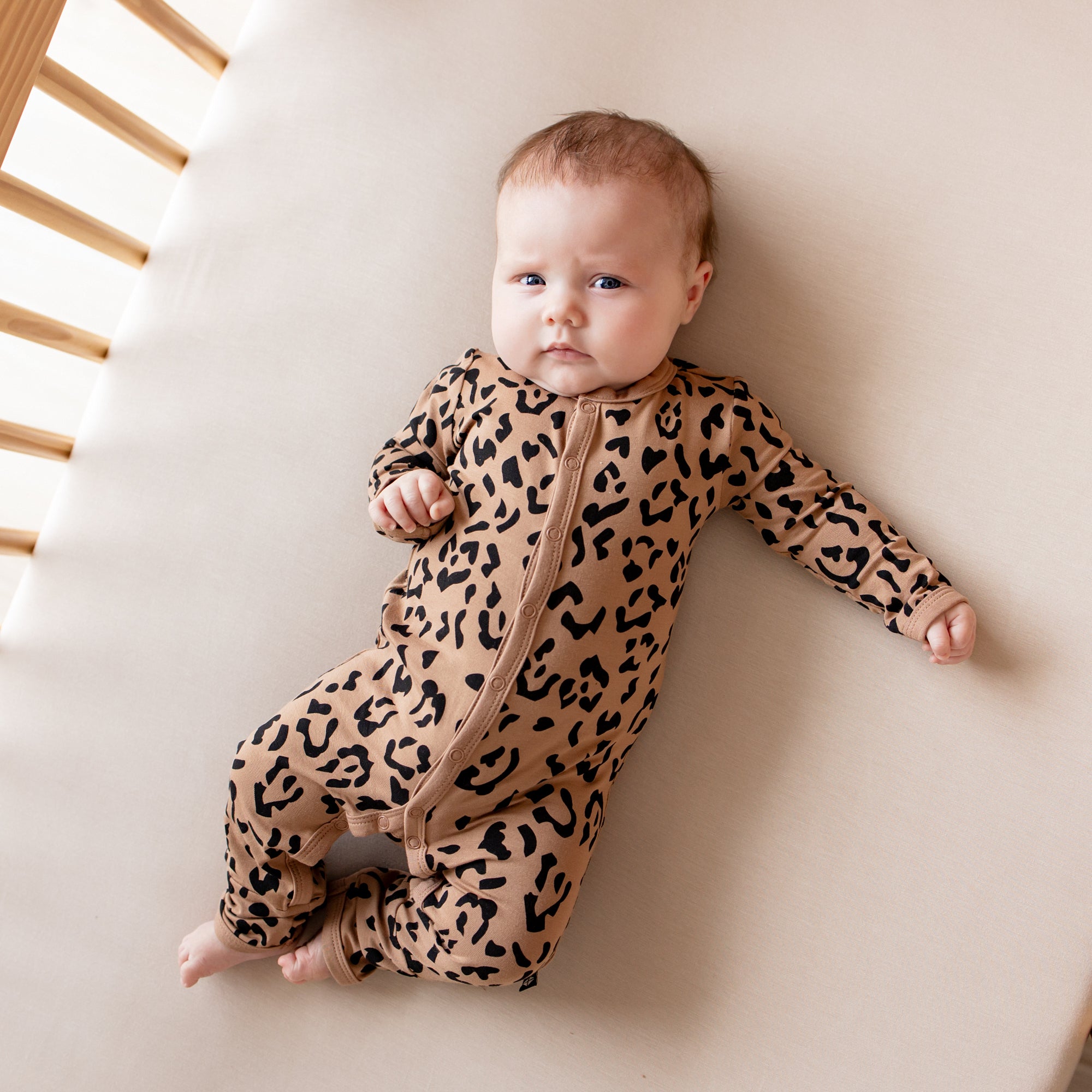 Baby wearing leopard print pajamas snap romper