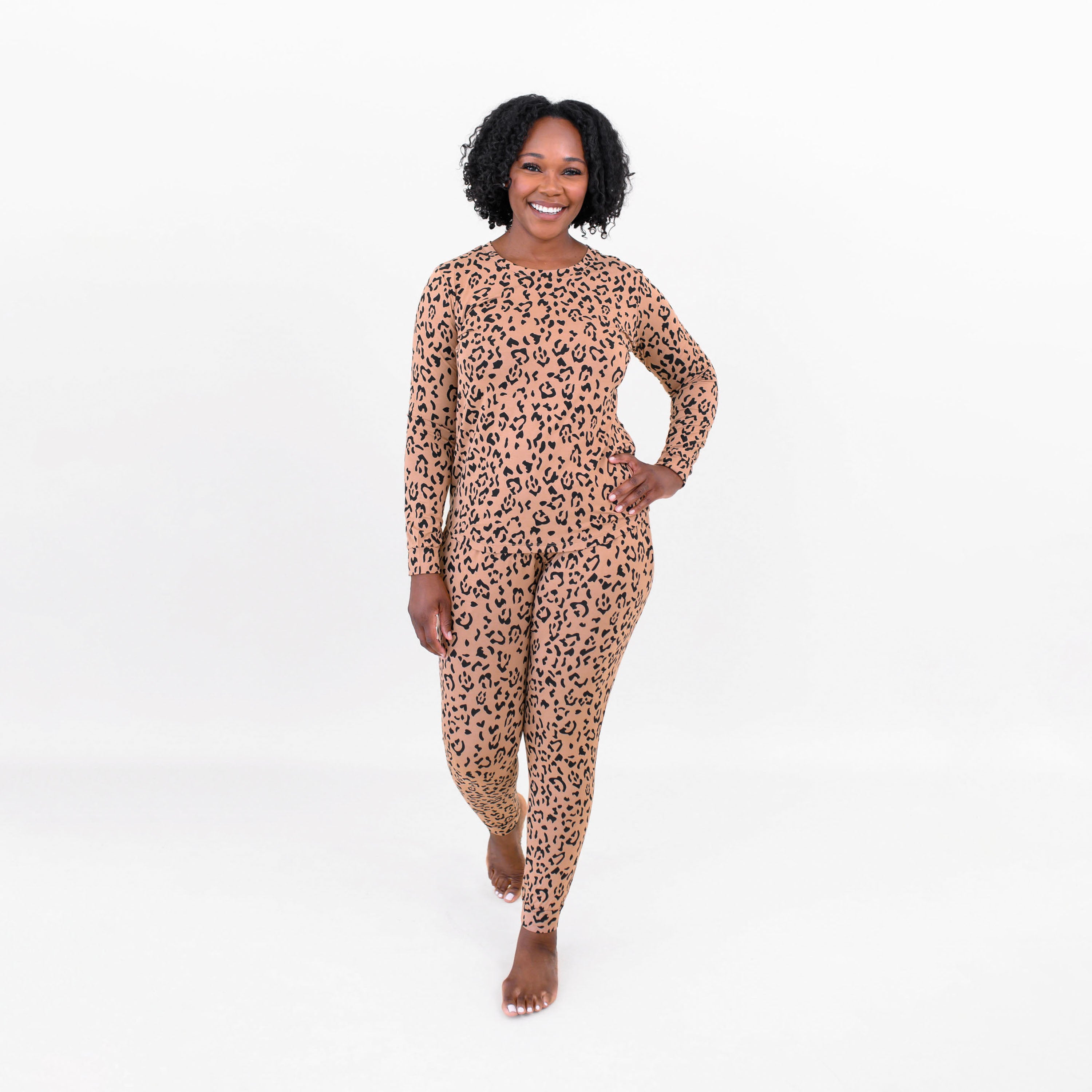 Female model walking with one hand on  her hip wearing the Women's Jogger Pajama Set in Latte Leopard