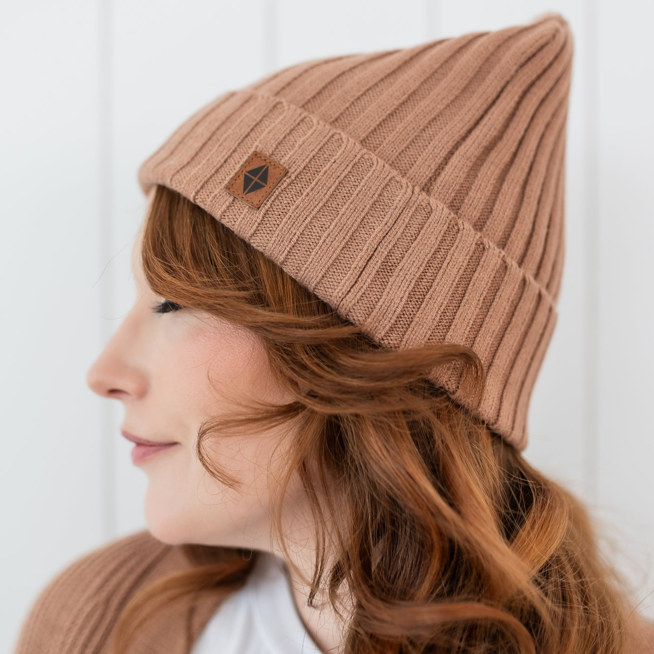 Close up of the Chunky Knit Adult Ribbed Beanie in Latte shown on a female model
