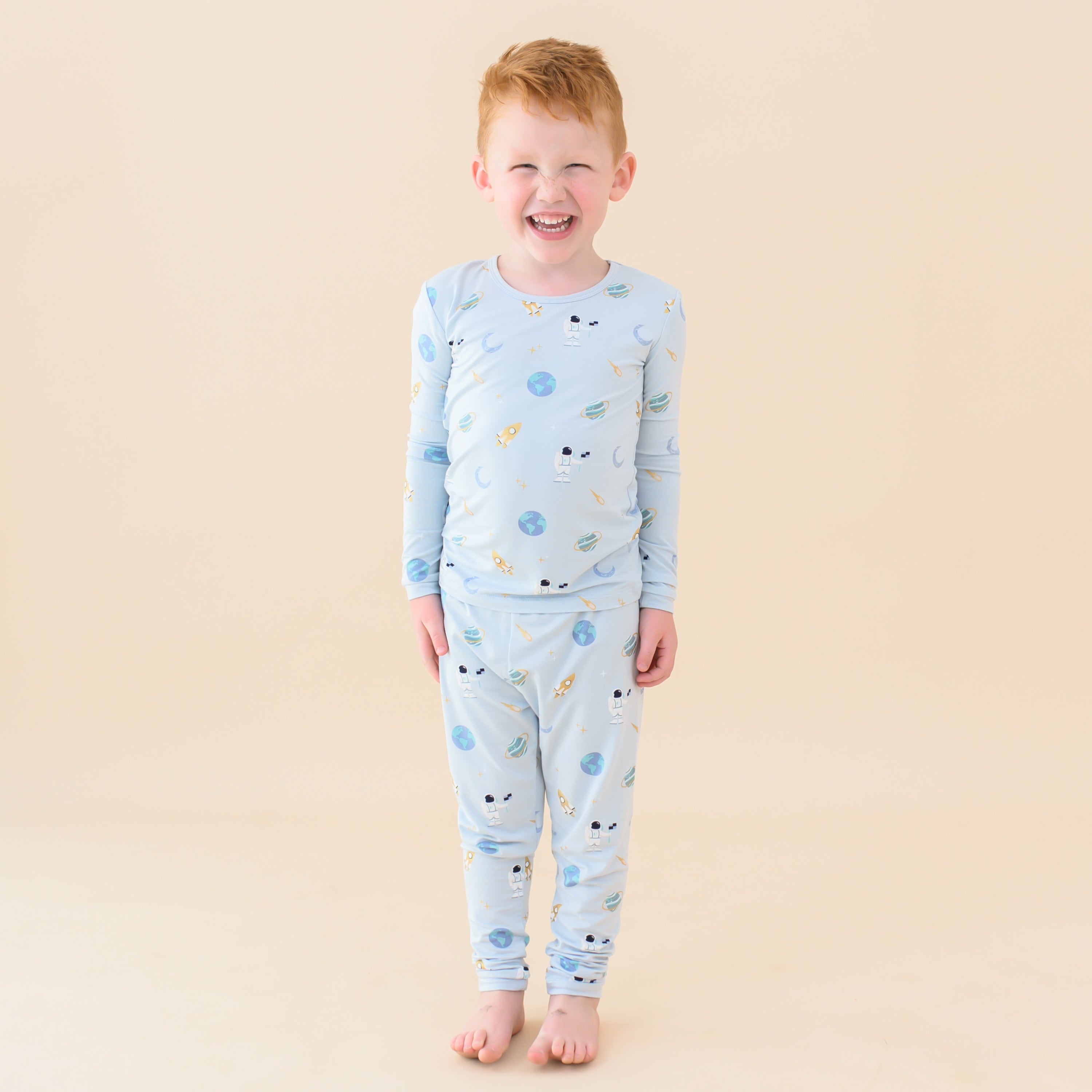 toddler smiling wearing long sleeve pajamas in ice space