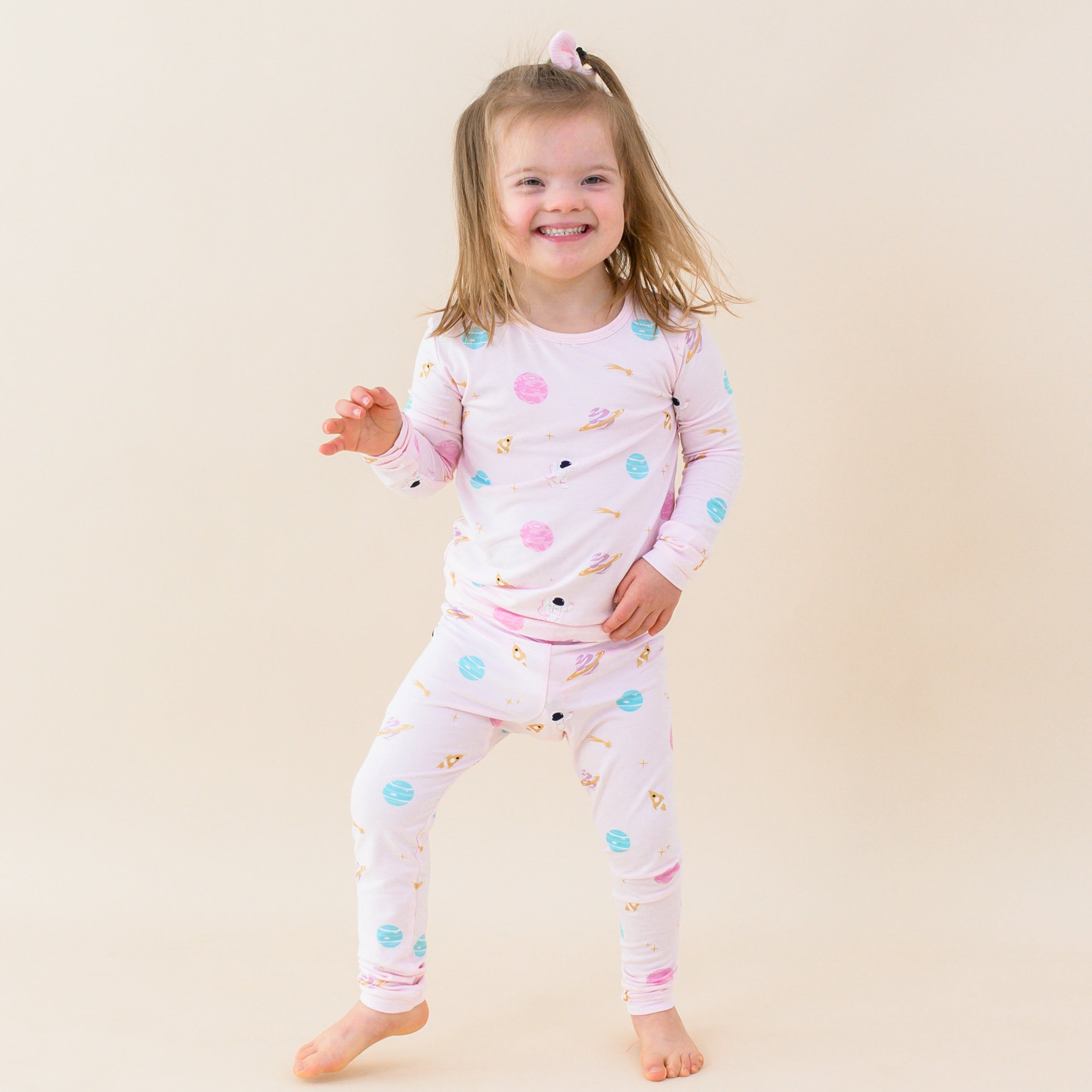 toddler standing and smiling sakura space long sleeve pajamas