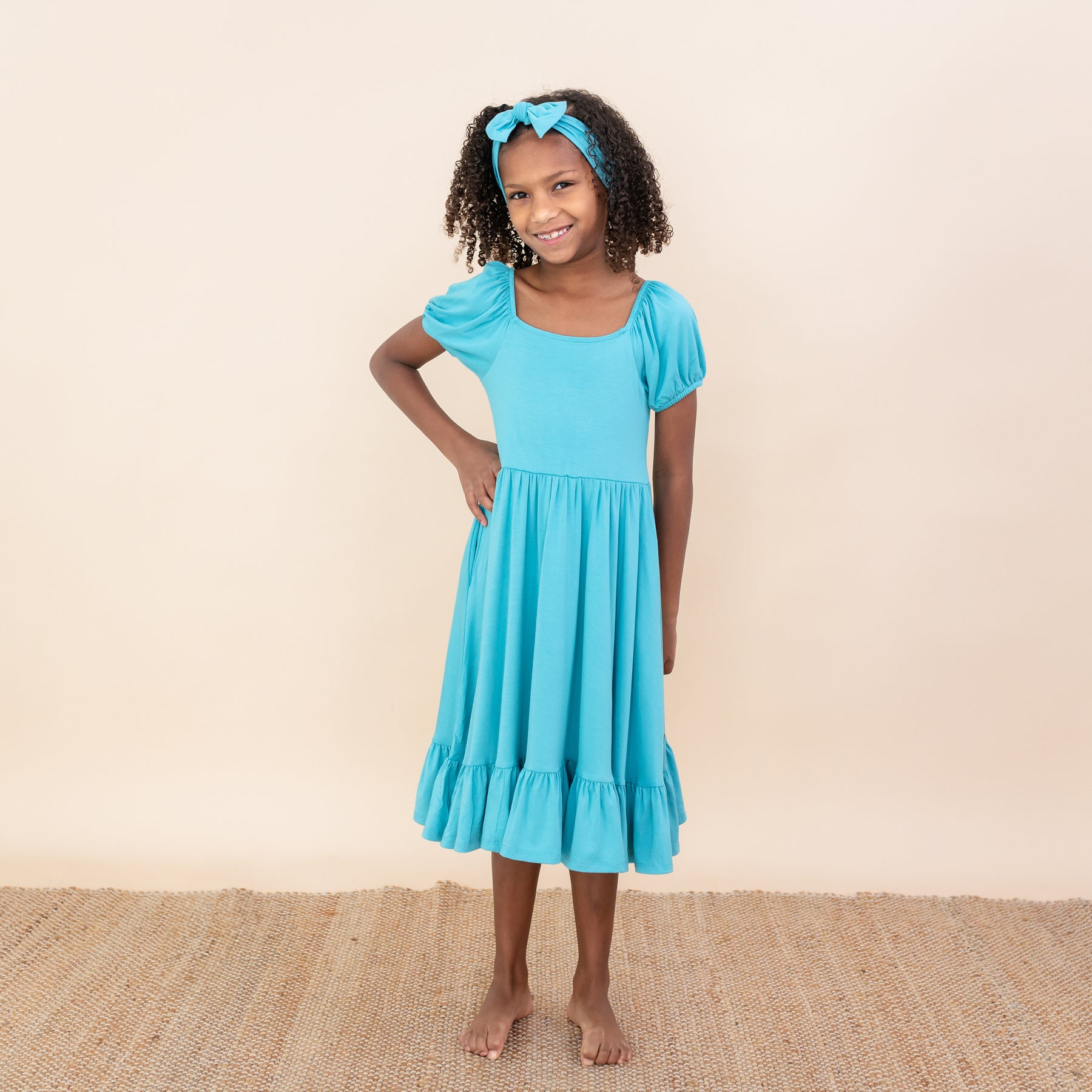 Child modeling Puff Sleeve Twirl Dress in Makai