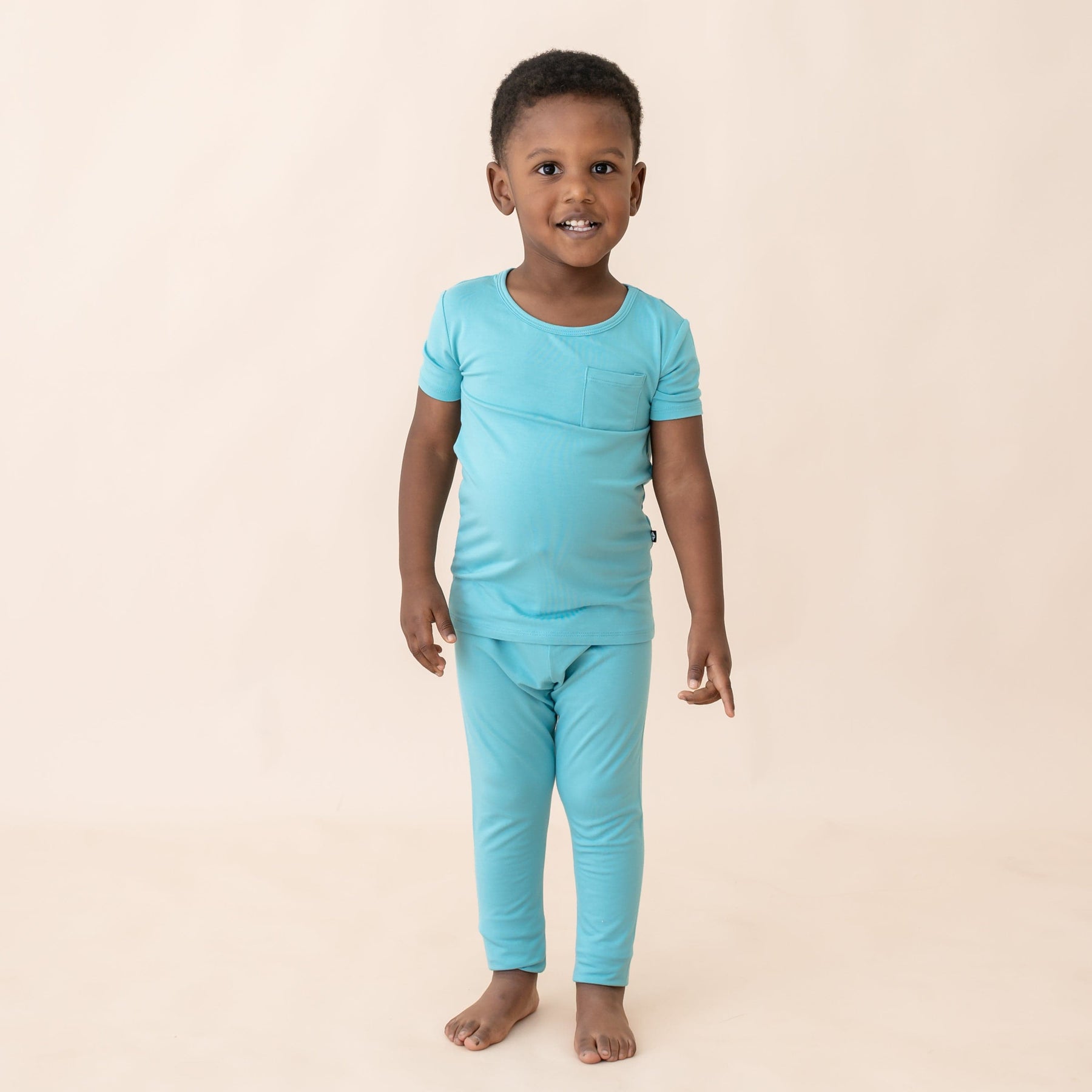 toddler modeling kyte baby short sleeve with pants pajamas in makai