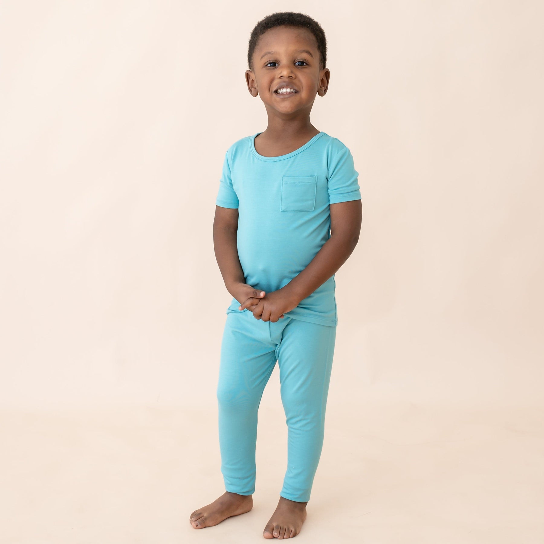 toddler modeling kyte baby short sleeve with pants pajamas in makai