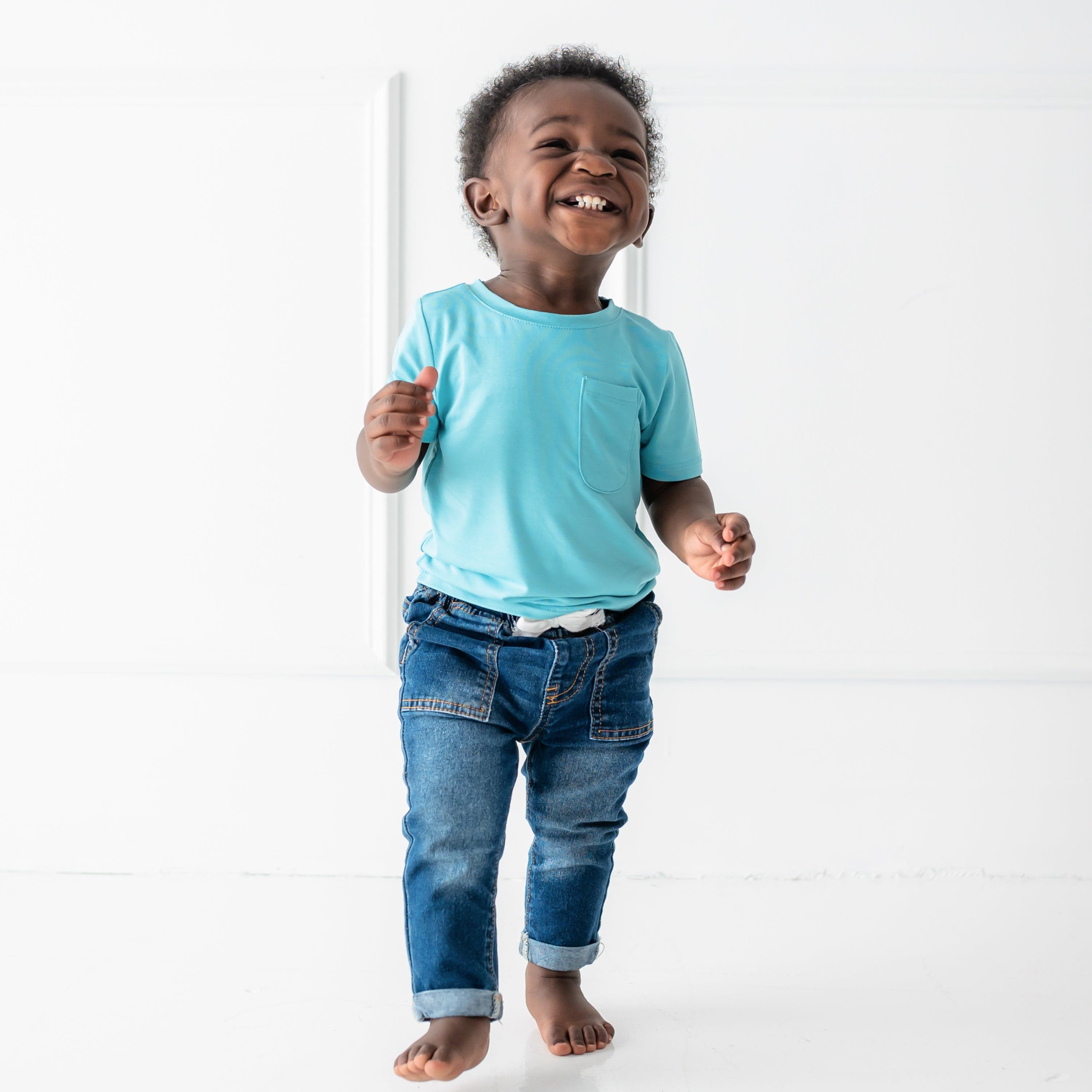 toddler smiling and wearing short sleeve crew neck tee in makai