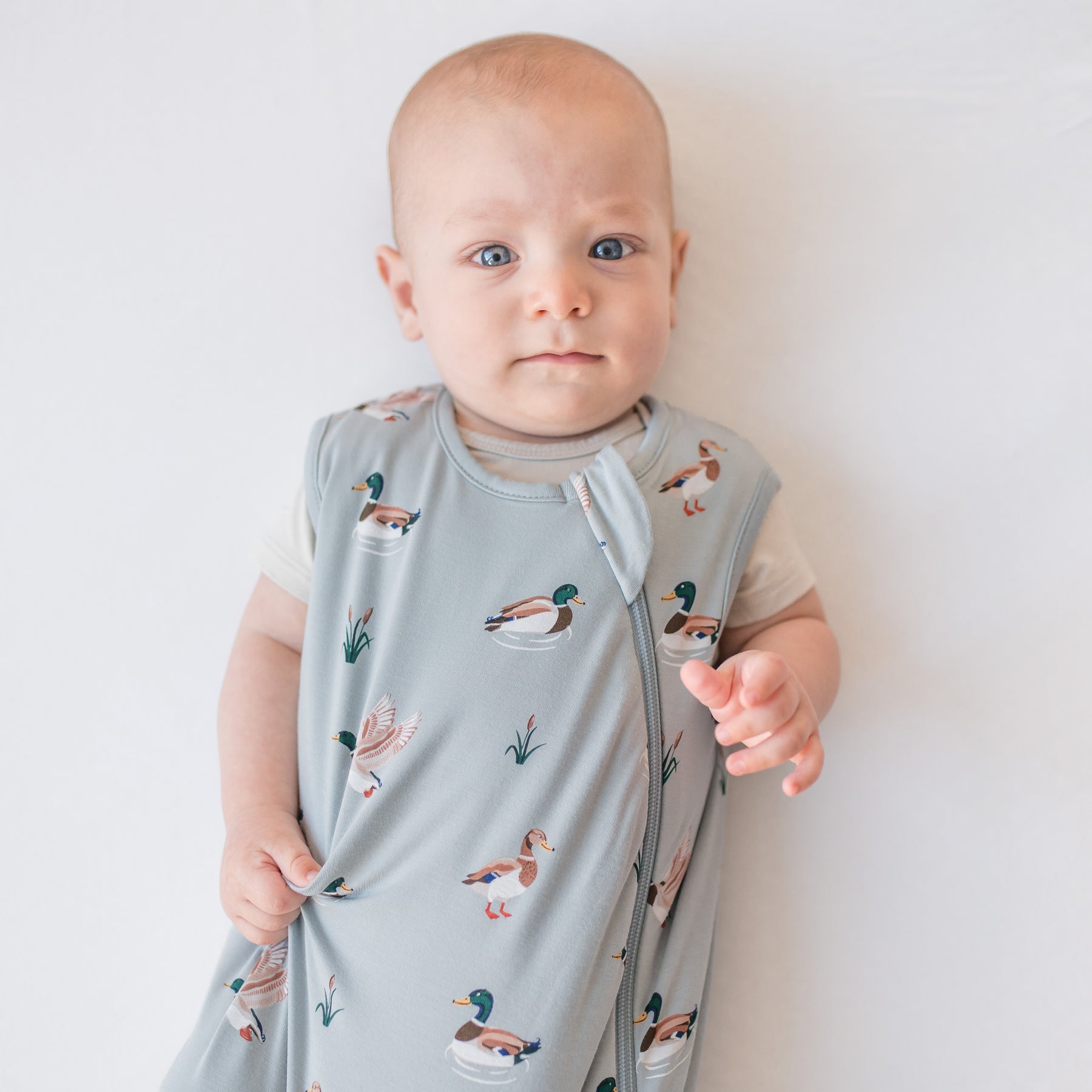 Close up of infant wearing the Sleep Bag in Mallard Duck 0.5