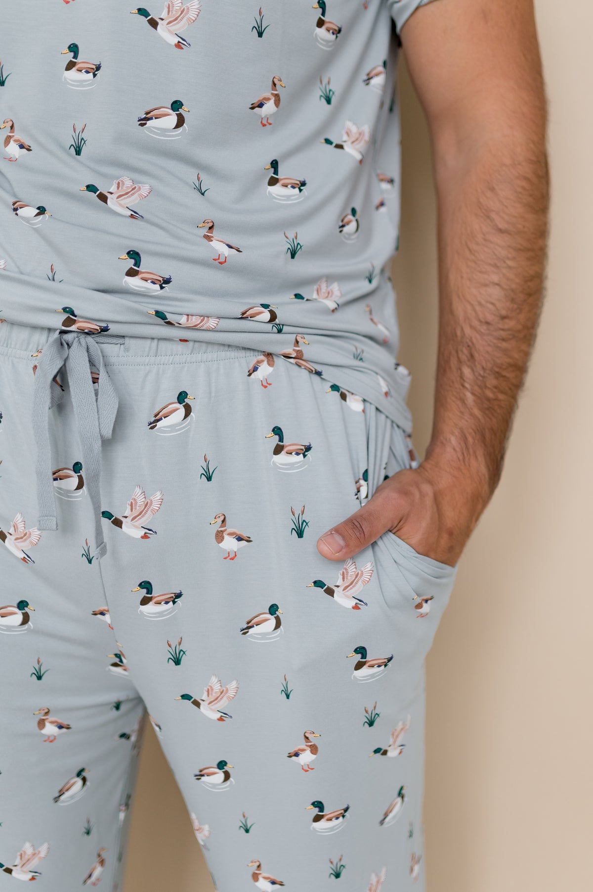 Close up of the drawstring waist and pocket on the Men's Lounge Pants in Mallard Duck shown on a male model