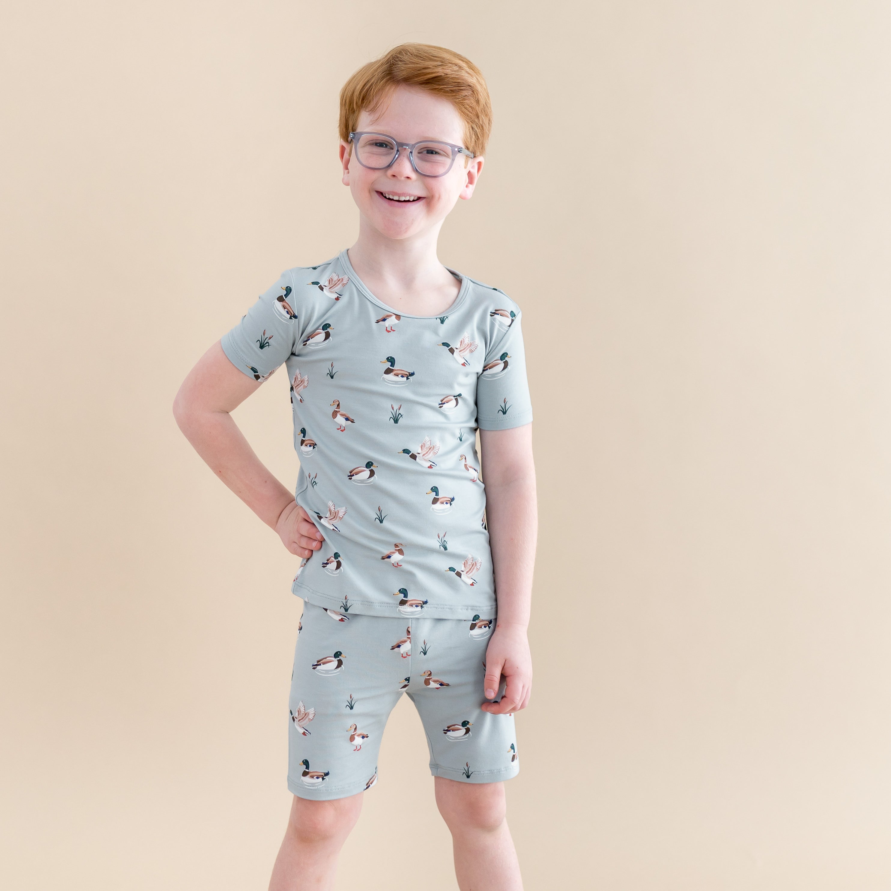 Close up of the Short Sleeve Pajamas in Mallard Duck shown on a smiling boy