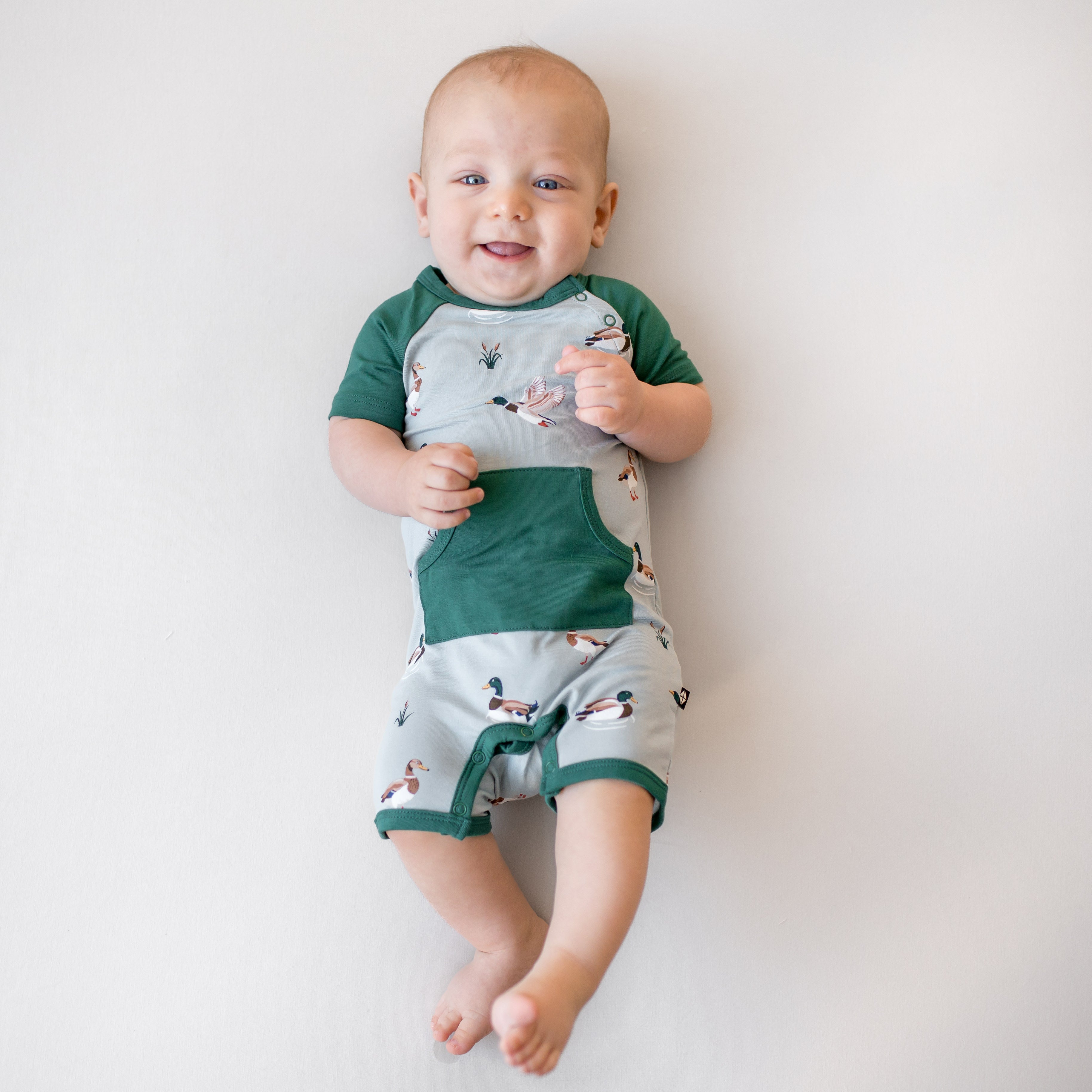 Young infant wearing the Shortall in Mallard Duck