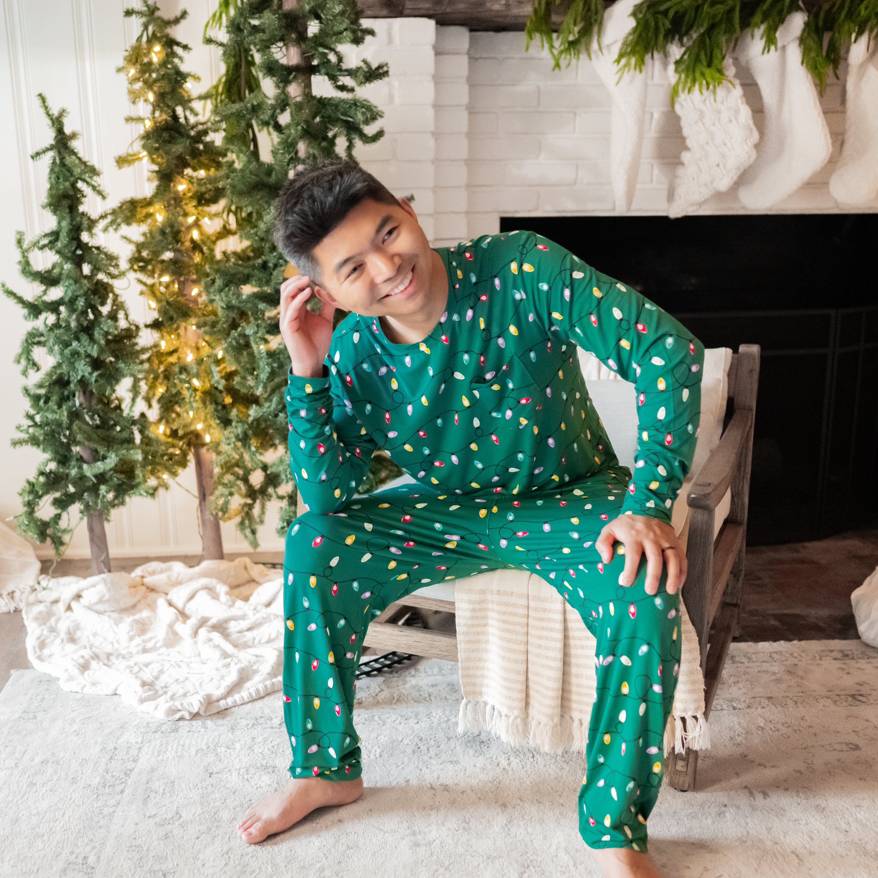 Male model sitting in a chair wearing the Men's Jogger Set in Merry and Bright