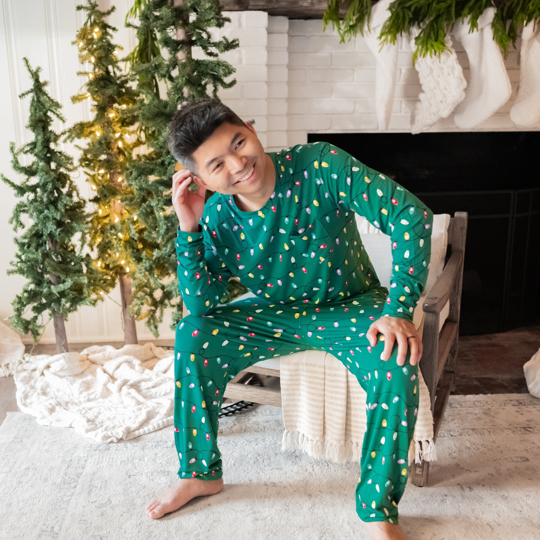 Male model sitting in a chair wearing the Men's Jogger Set in Merry and Bright