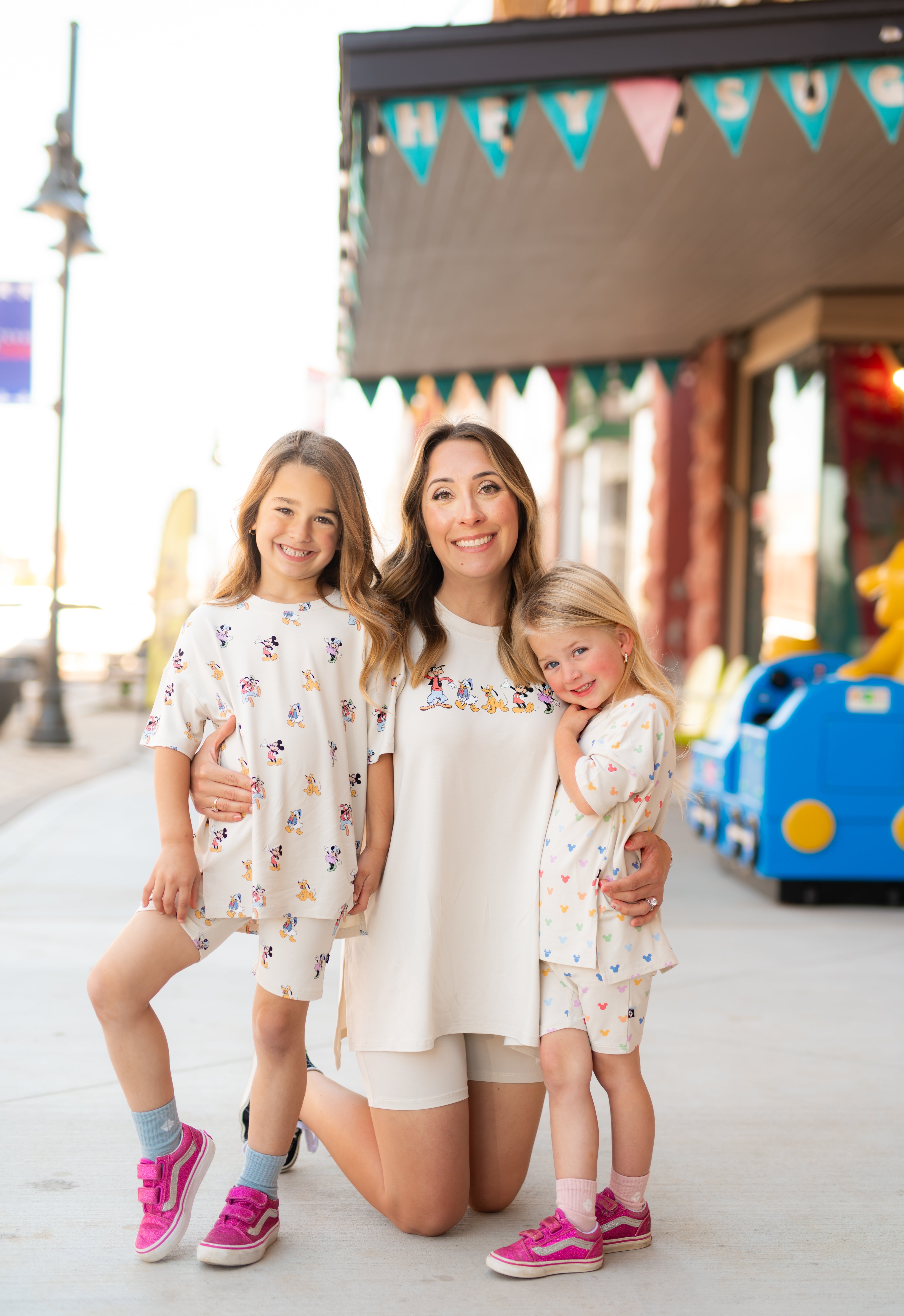 mom with 2 kids wearing biker short sets with mickey mouse patterns 