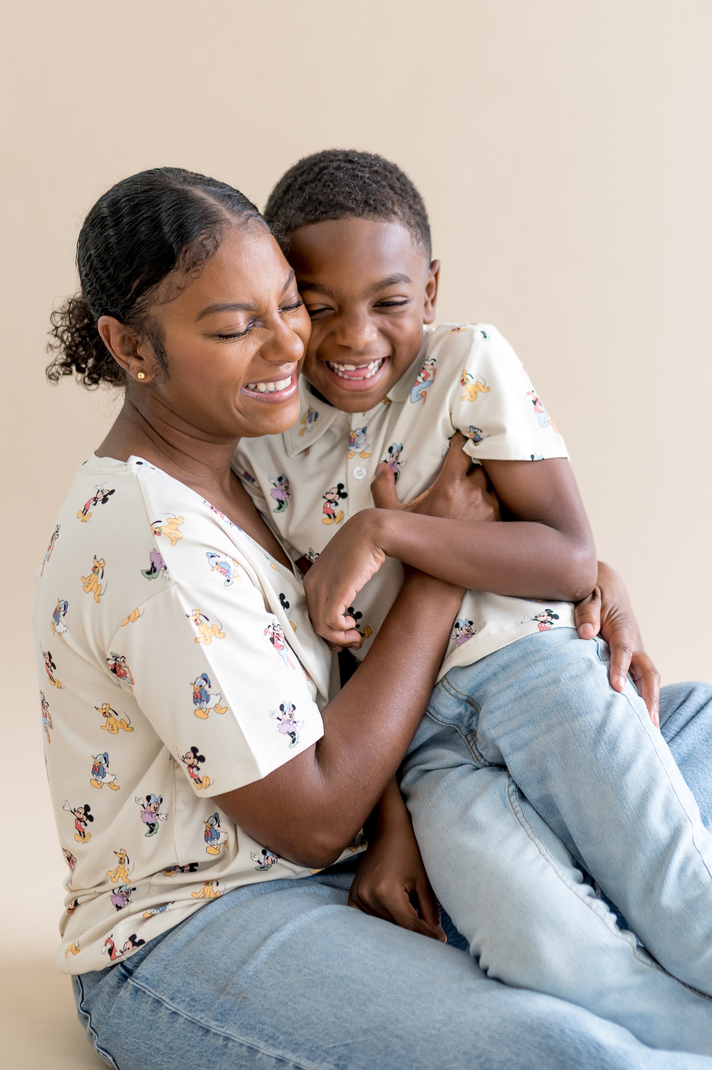 Mom and child wearing matching mickey mouse patterned shirts