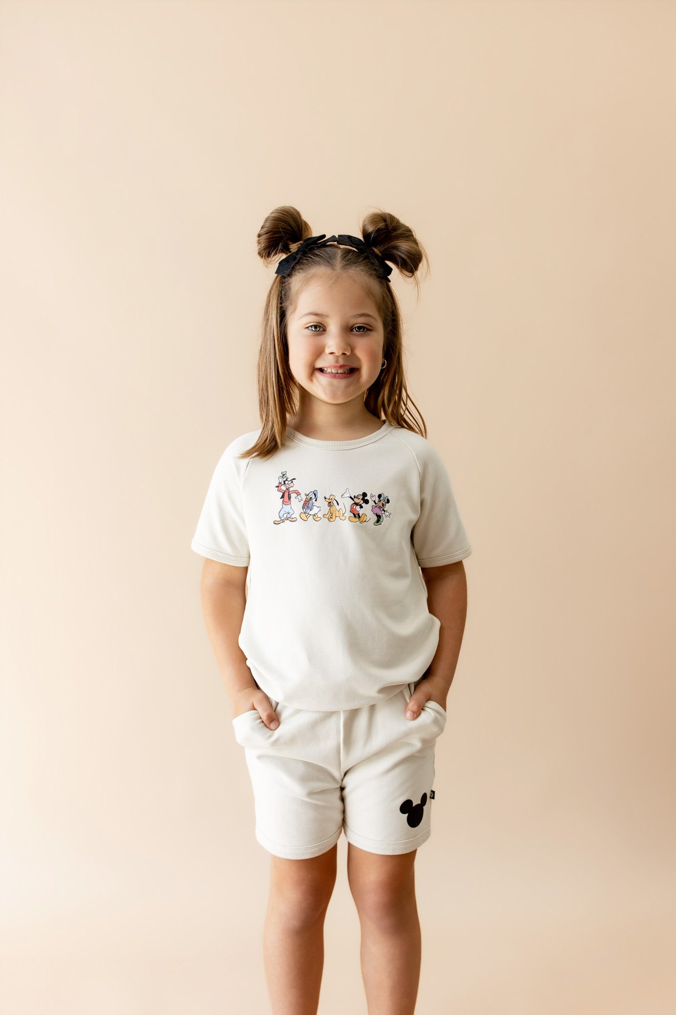 Toddler wearing matching set with mickey characters and mickey head 