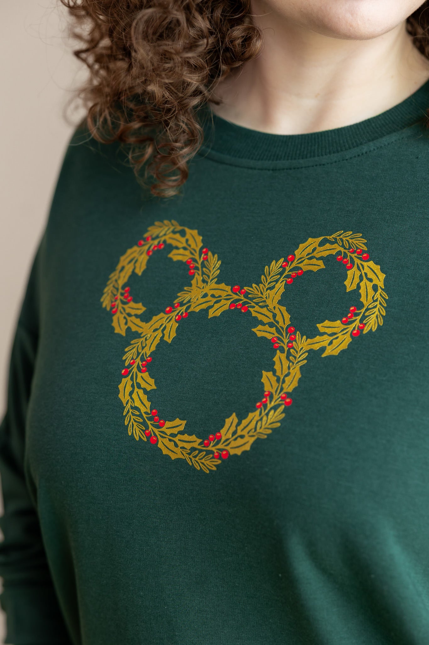 close up of modal wearing Women's Sweatshirt with Mickey Christmas Wreath print on Cypress color