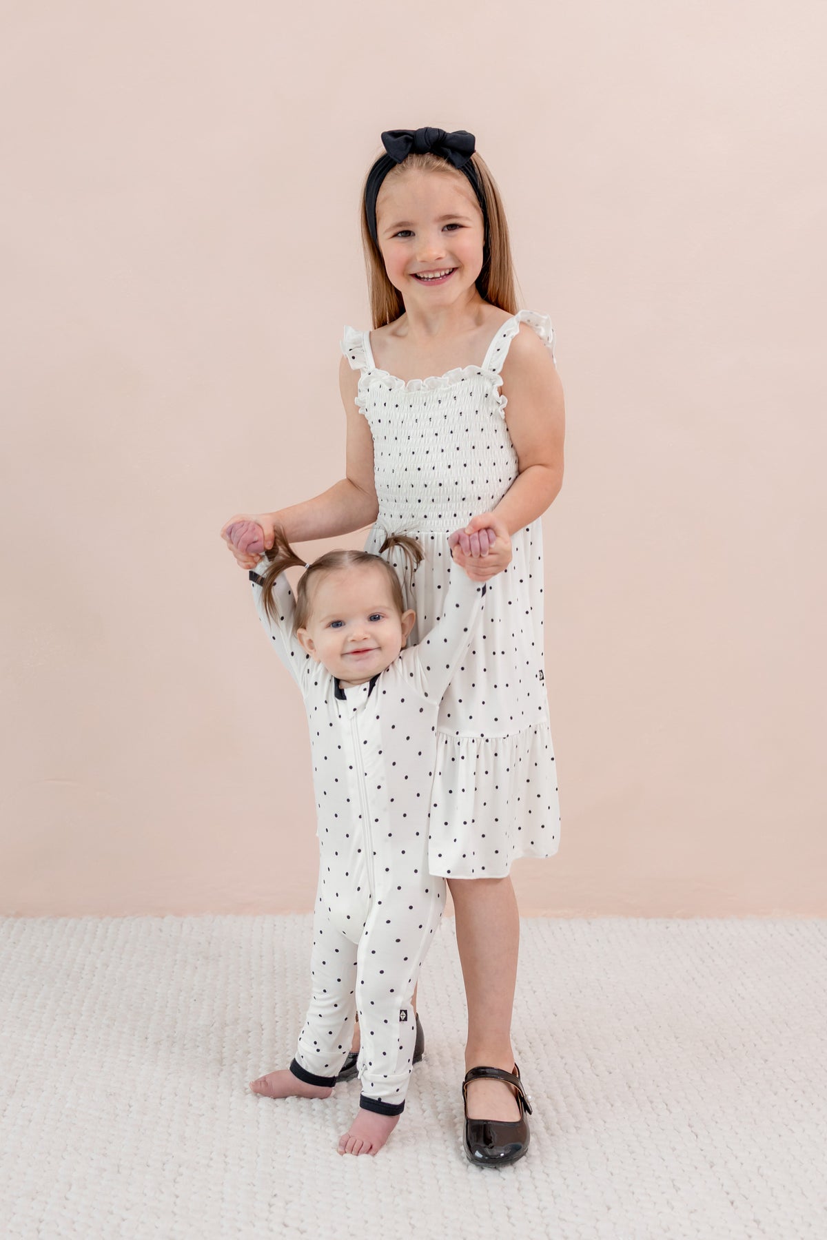 Sisters both wearing polka dot outfits 