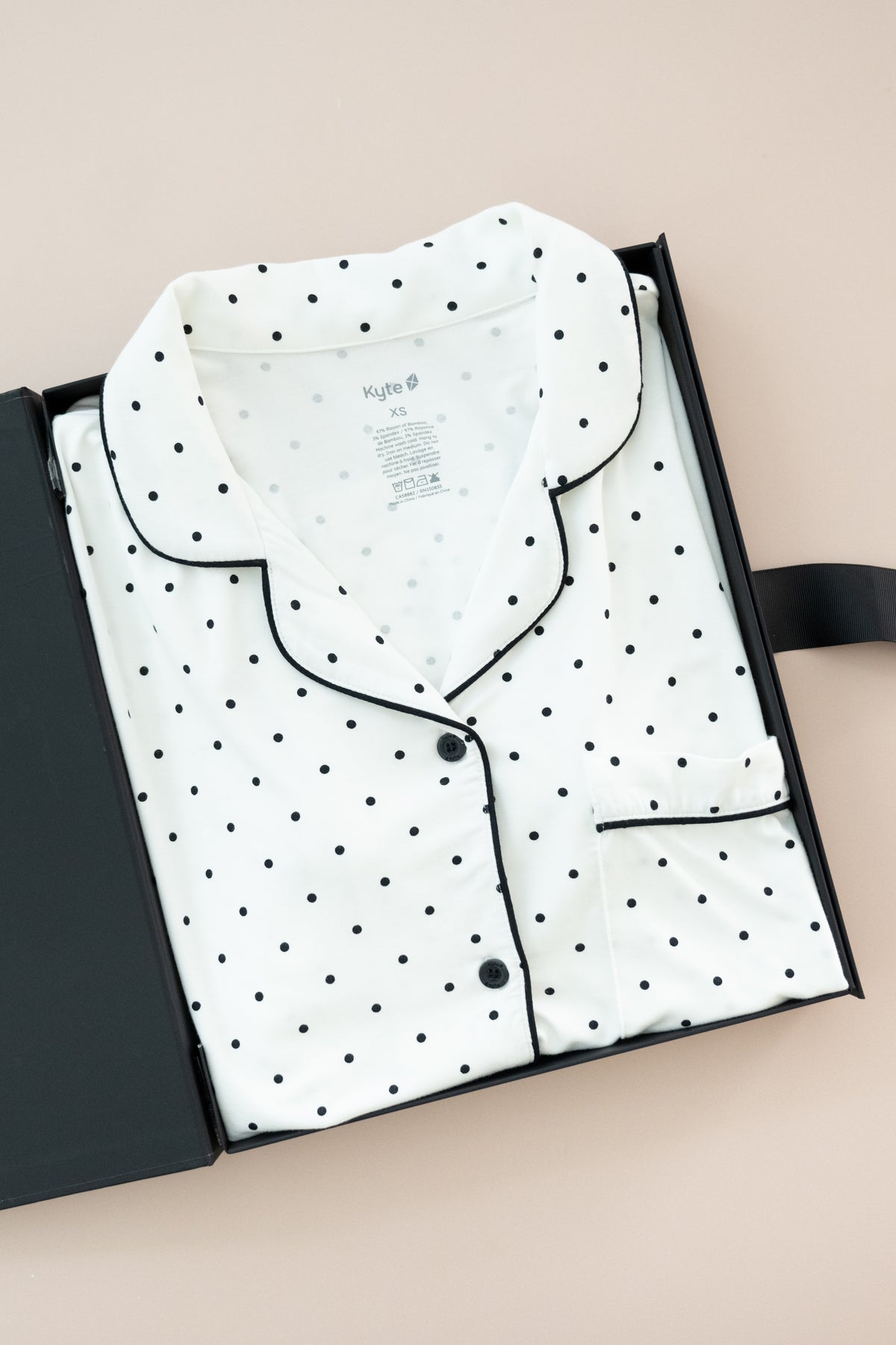 Women's Short Sleeve Pajama Set in Midnight Polka Dot print packed in a box on a beige background