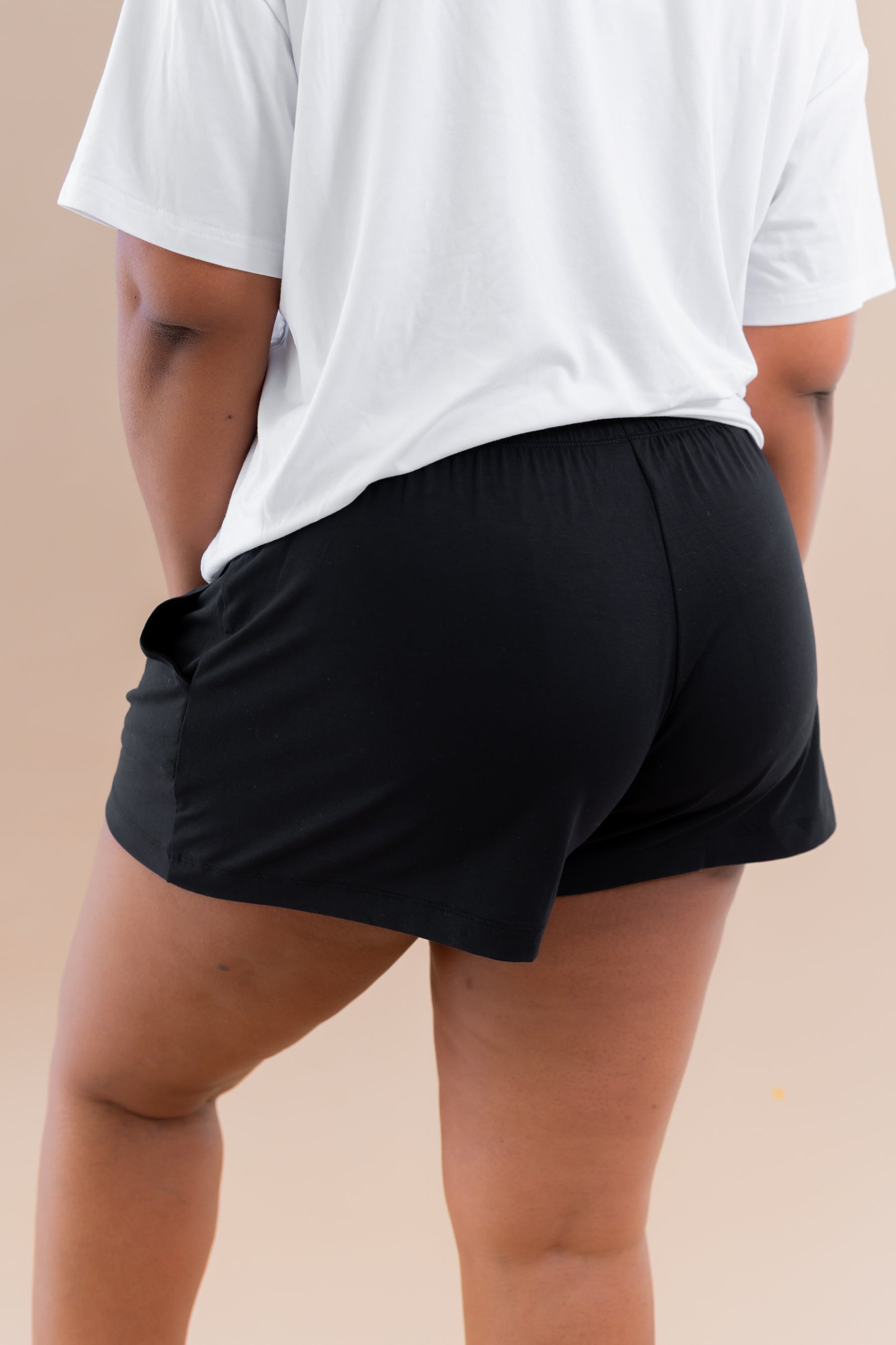 The back of the Women's Lounge Shorts in Midnight shown on a female model