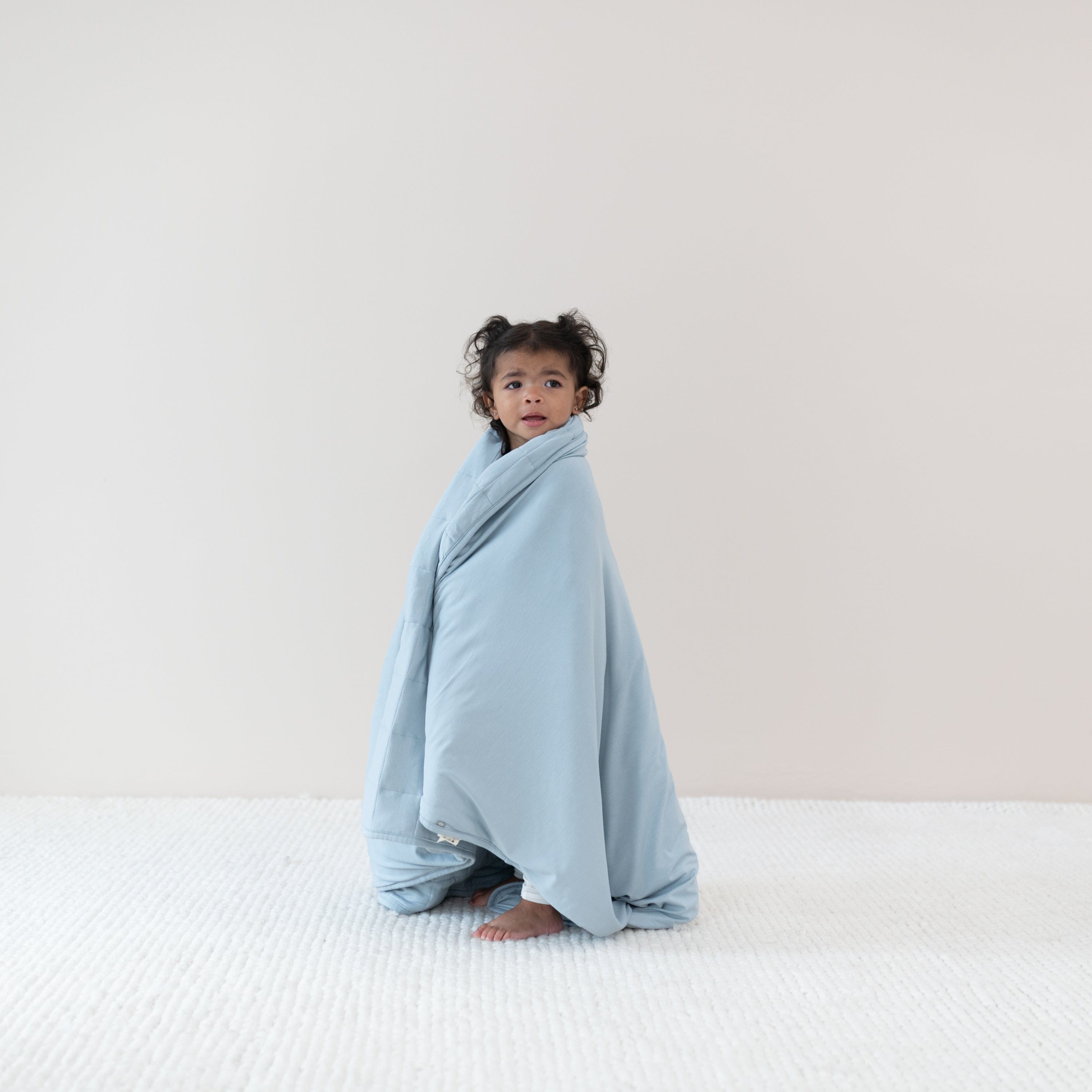 Standing toddler wrapped in Toddler Blanket in Fog 1.0