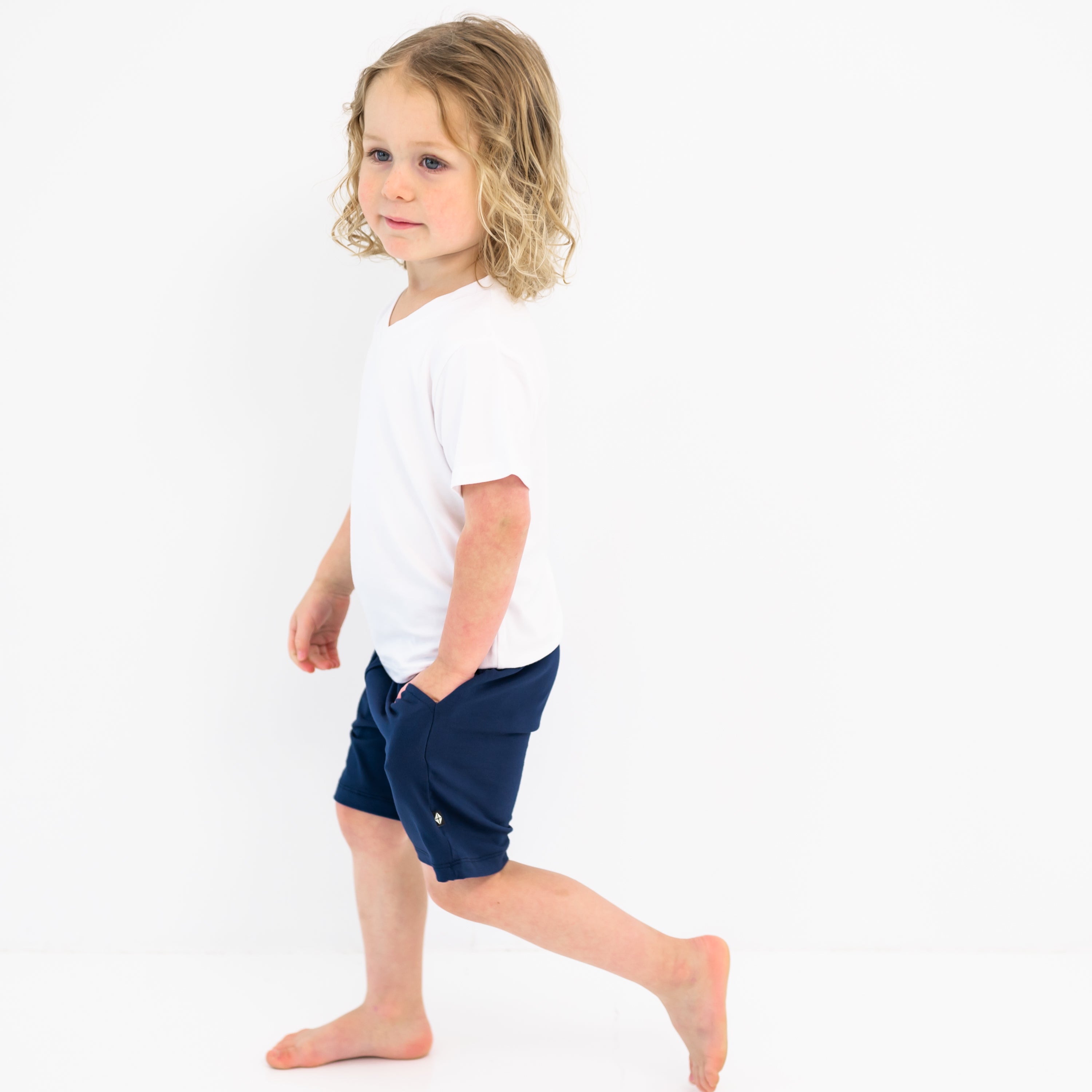 Toddler modeling Drawstring Short in Navy and Snow V-neck
