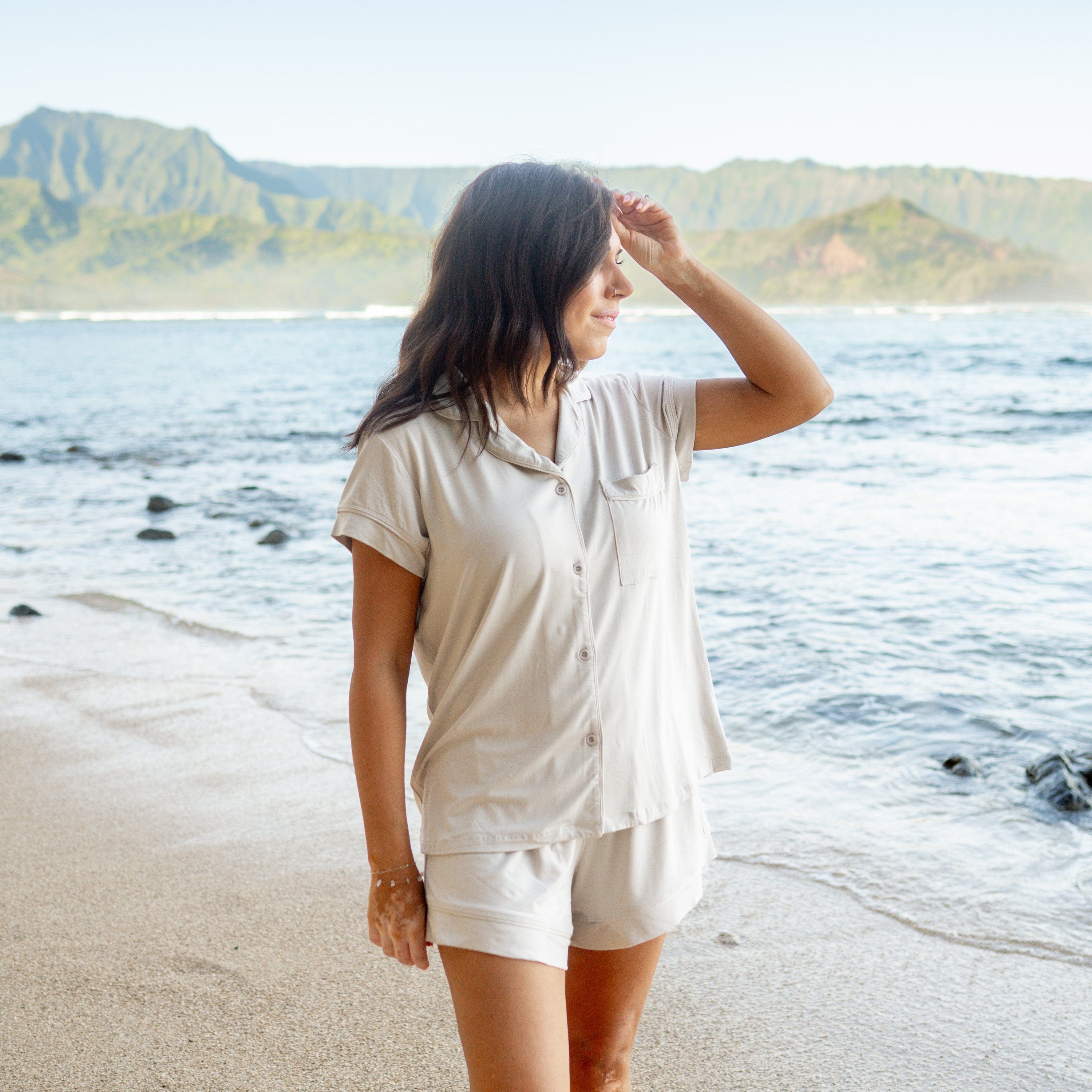 Woman modeling Women’s Short Sleeve Pajama Set in Oat on beach
