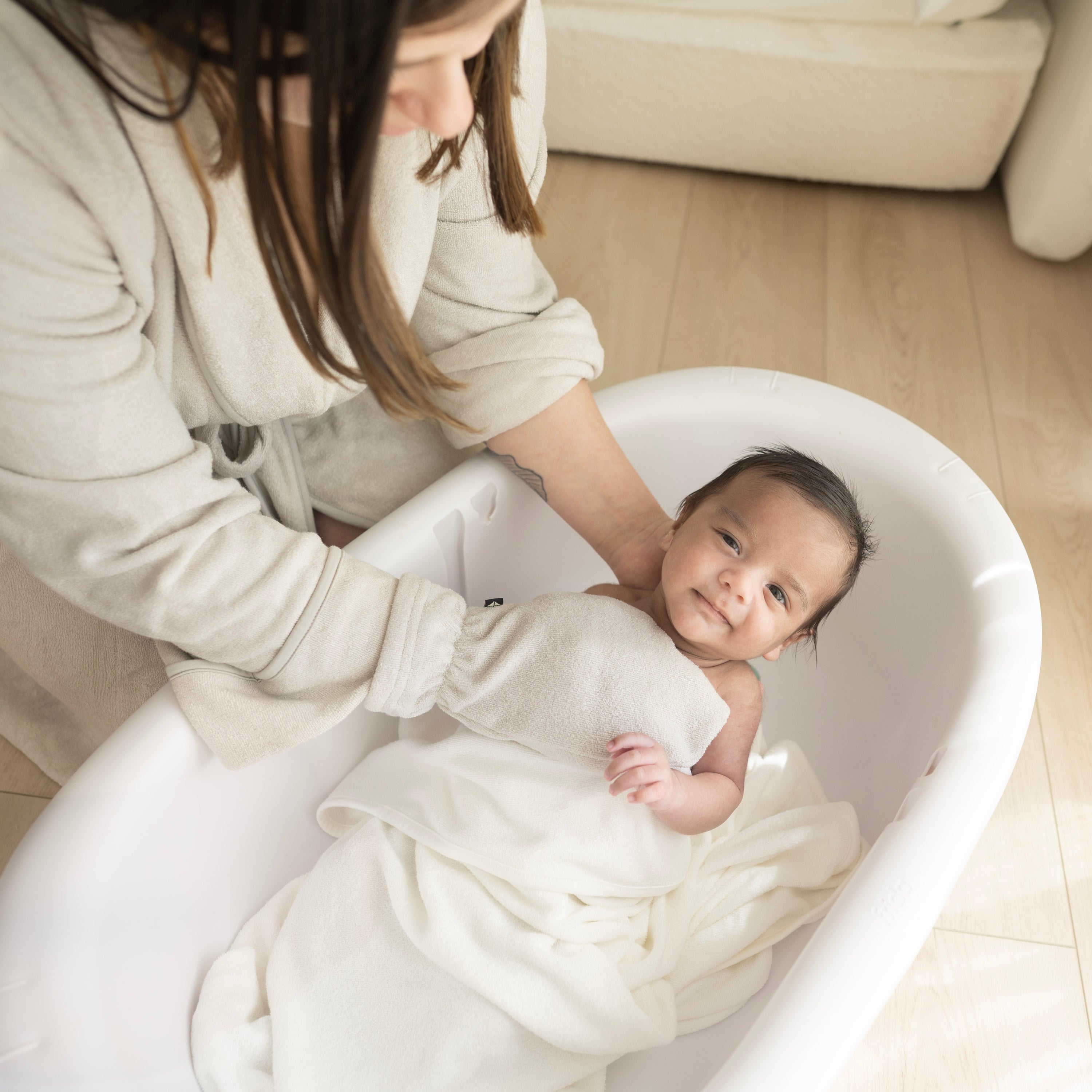 Mom using Bamboo Terry Bath Mitt in Oat to Bathe Newborn