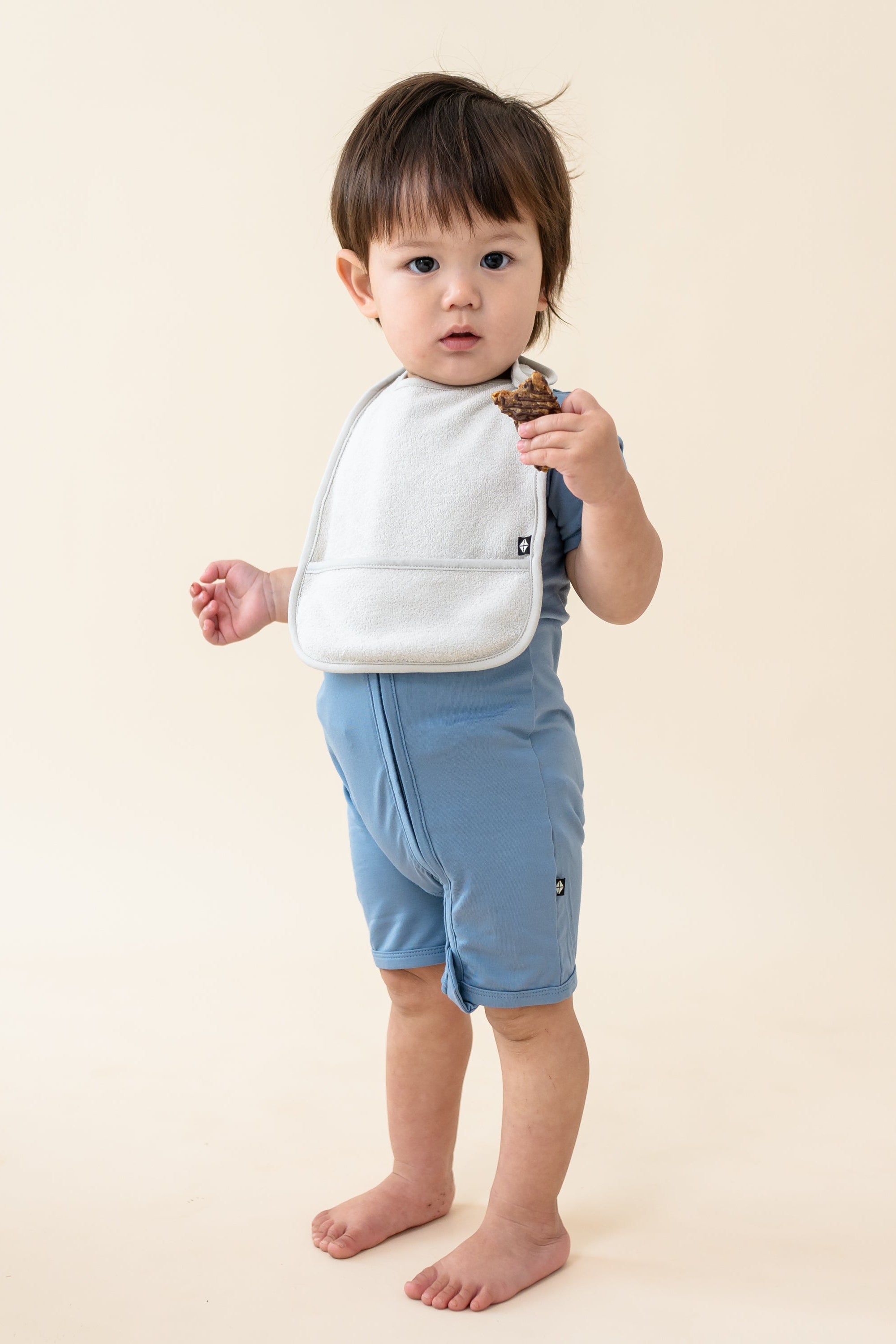 Toddler wearing Terry Pocket Bib in Oat
