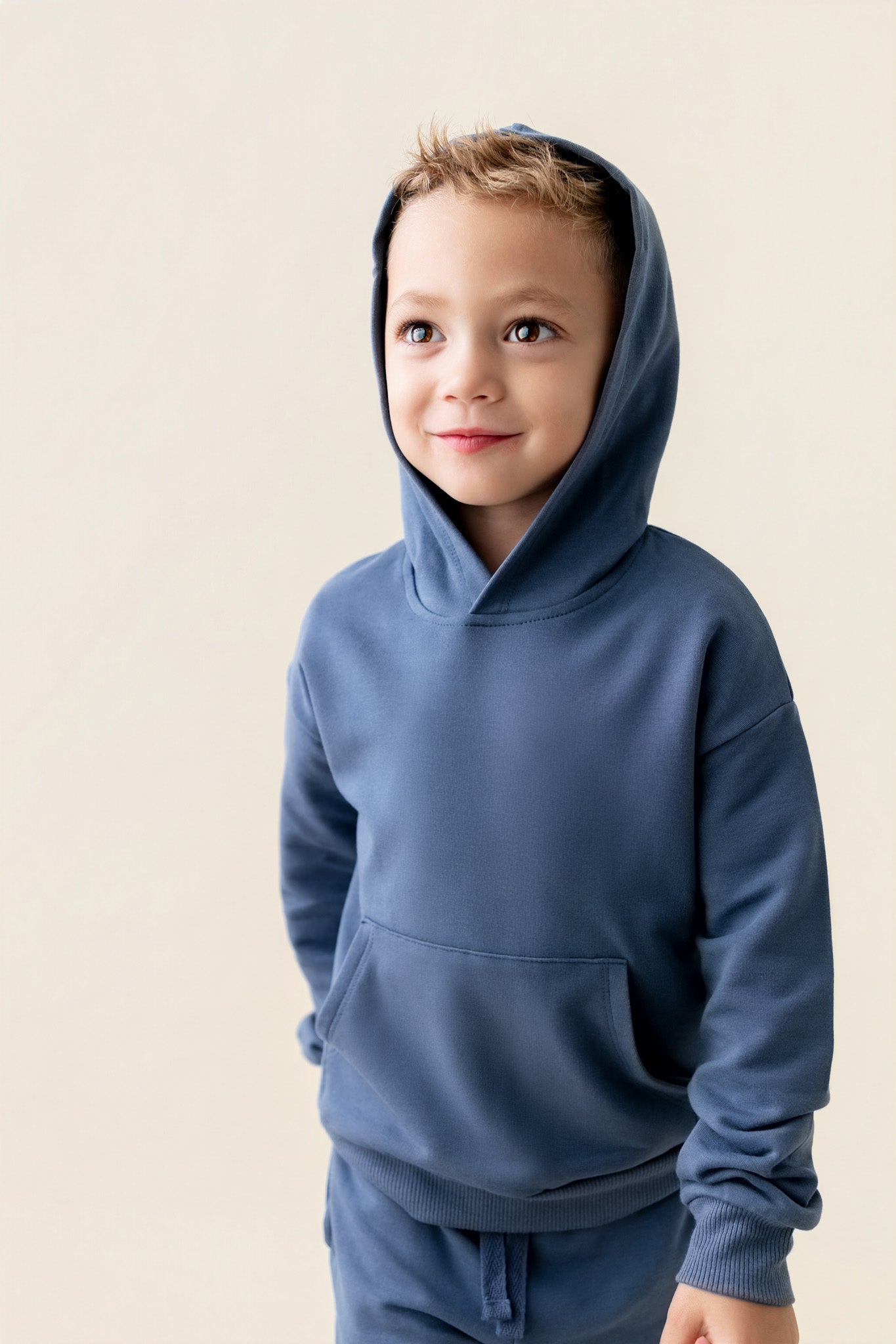 Boy wearing Hoodie in Oxford color on a beige background