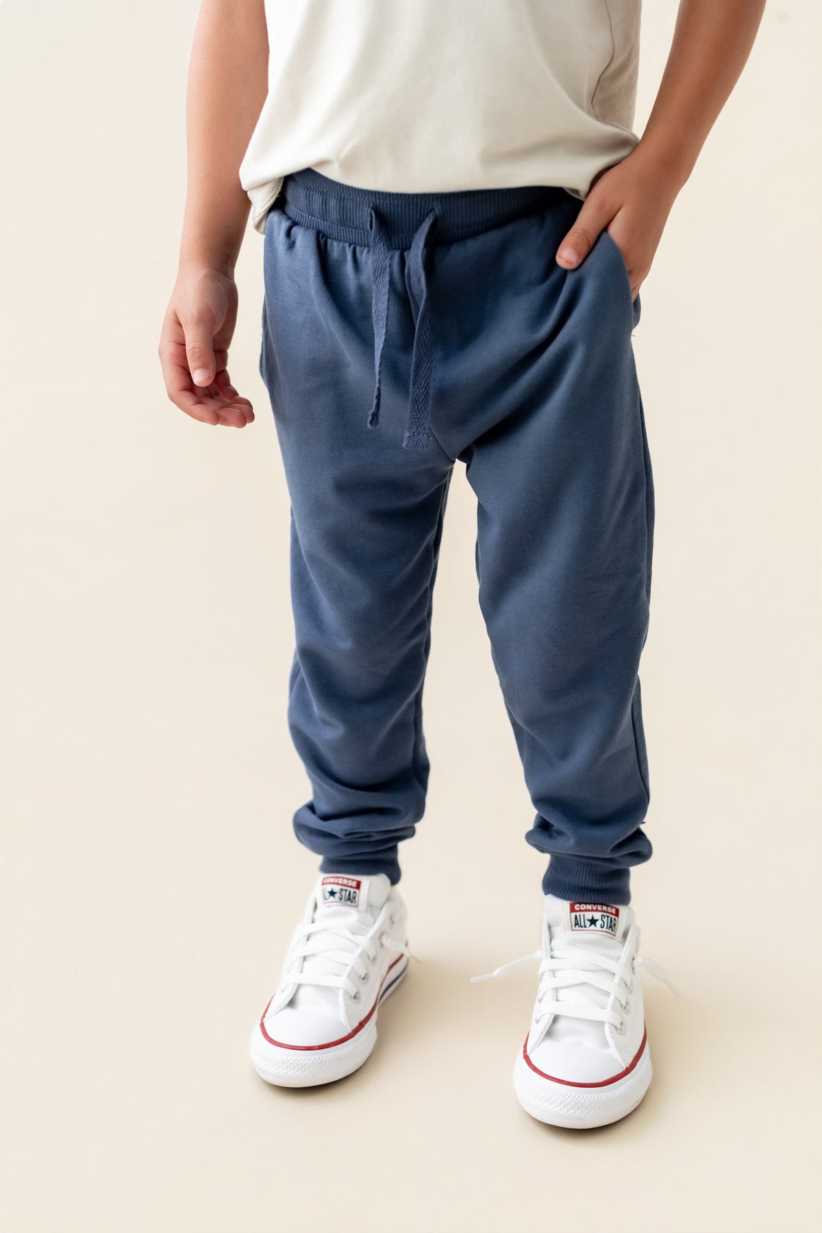 Modal wearing Jogger Pant in Oxford color under white T-shirt on a beige background