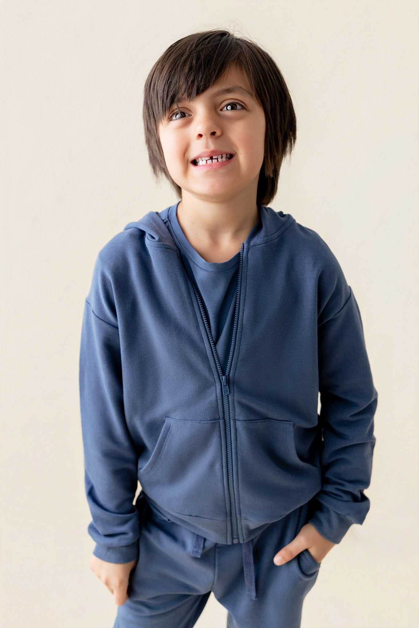 Boy wearing Hoodie in Oxford color on a beige background